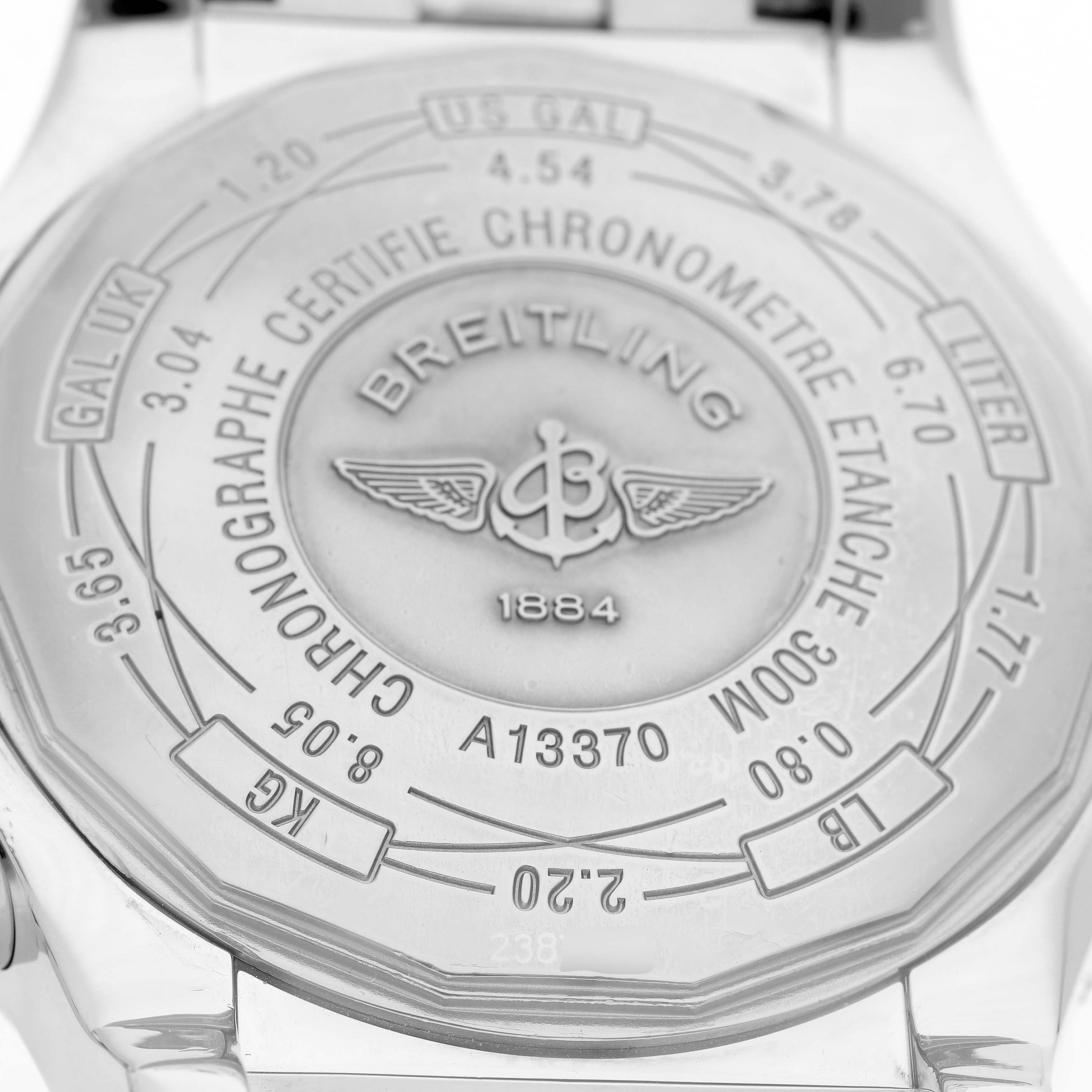 The image shows the back of the Breitling Avenger A1337011 / B907 Men's Stainless Steel Black Dial watch, highlighting its engravings and logo.