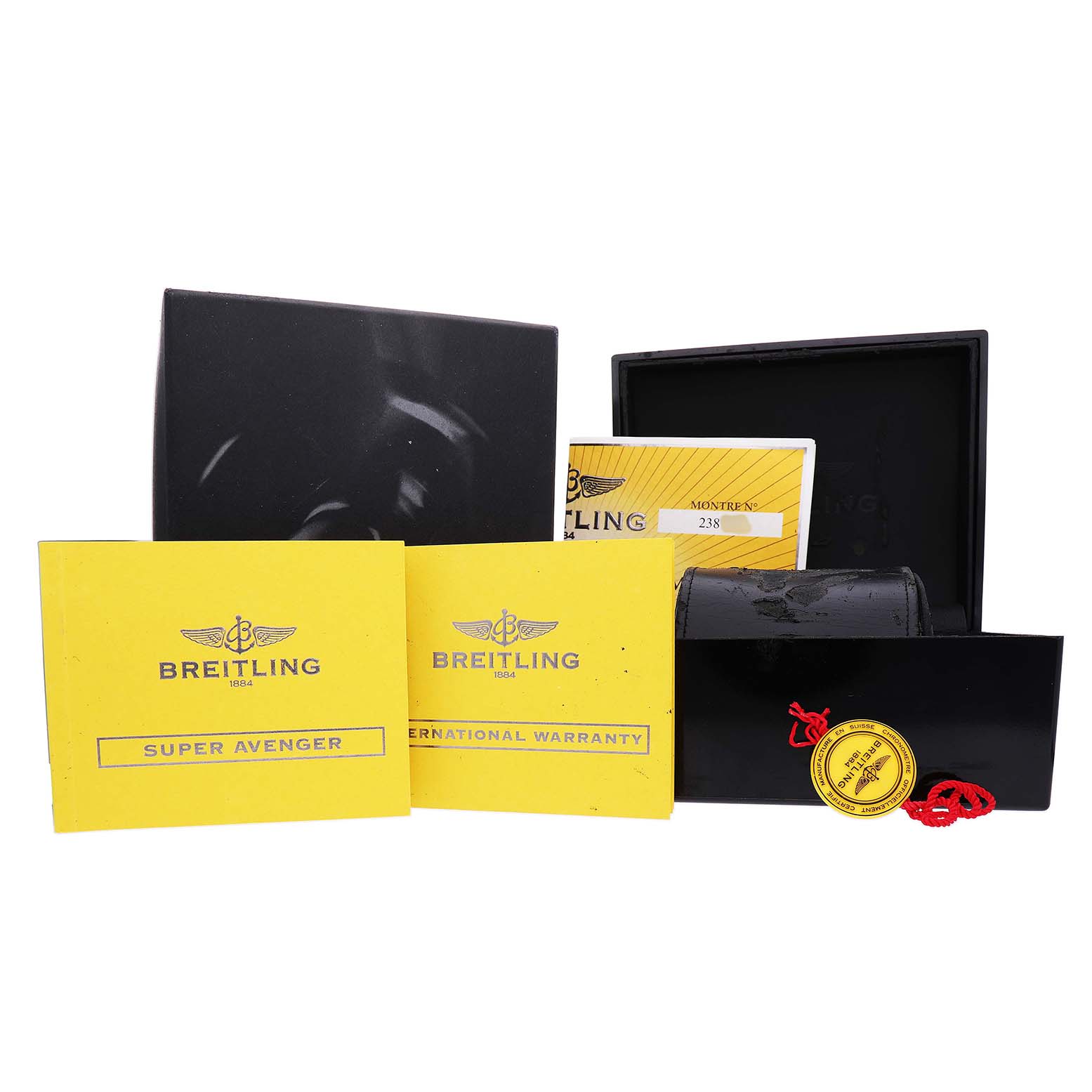 The image shows Breitling Avenger A1337011 / B907 Men's Stainless Steel Black Dial watch accessories, including an open box, warranty cards, and a tag, displayed from a front angle.