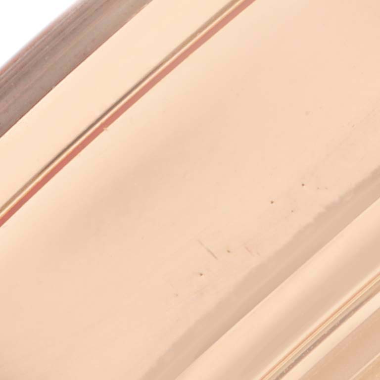 This image shows a close-up of the case side of a Breitling Transocean RB0152 Men's Rose Gold Silver Dial RB0152 Men's Rose Gold Silver Dial watch, highlighting its polished finish.