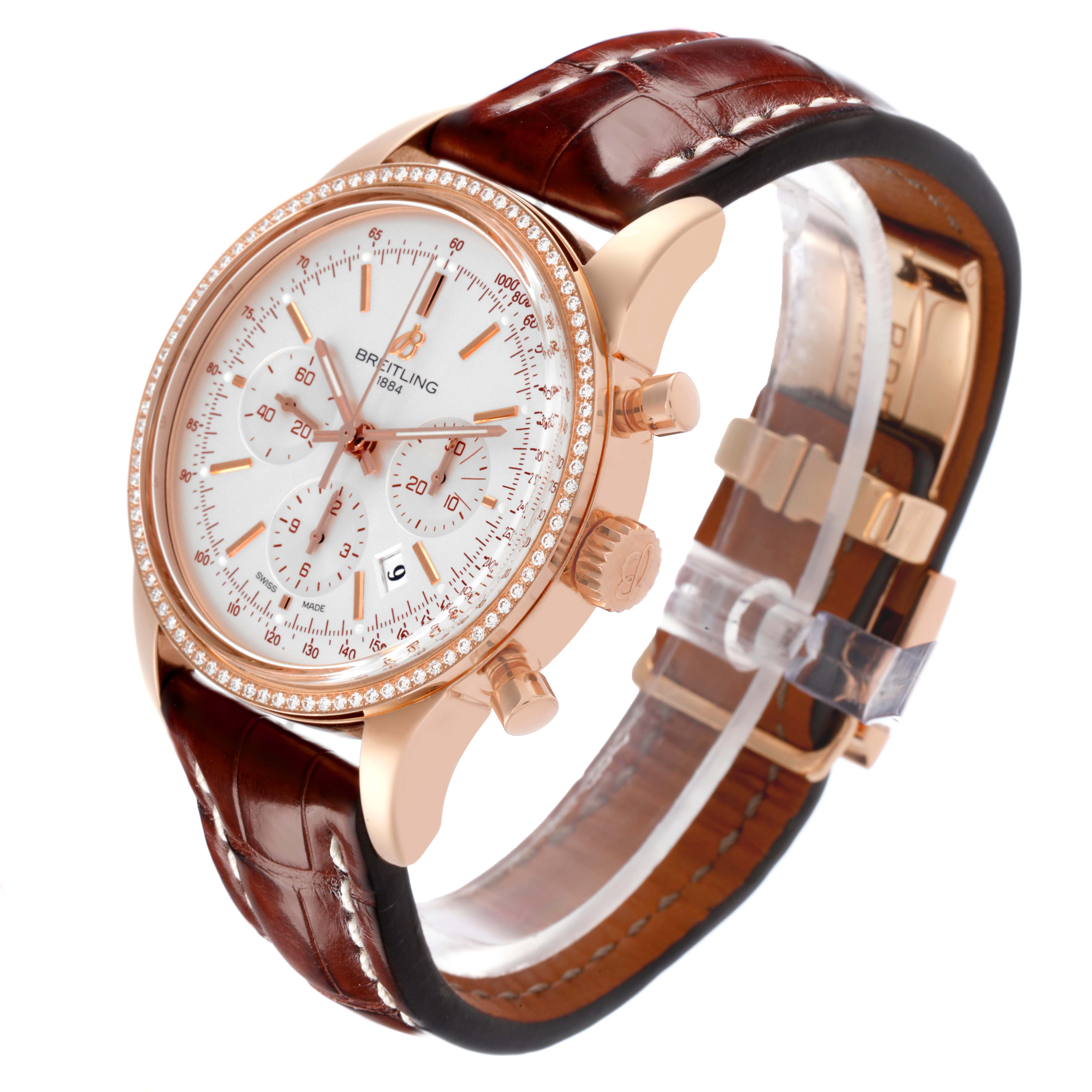 The Breitling Transocean RB0152 Men's Rose Gold Silver Dial RB0152 Men's Rose Gold Silver Dial watch is shown at a three-quarter angle, displaying the case, bezel, dial, crown, pushers, and leather strap.