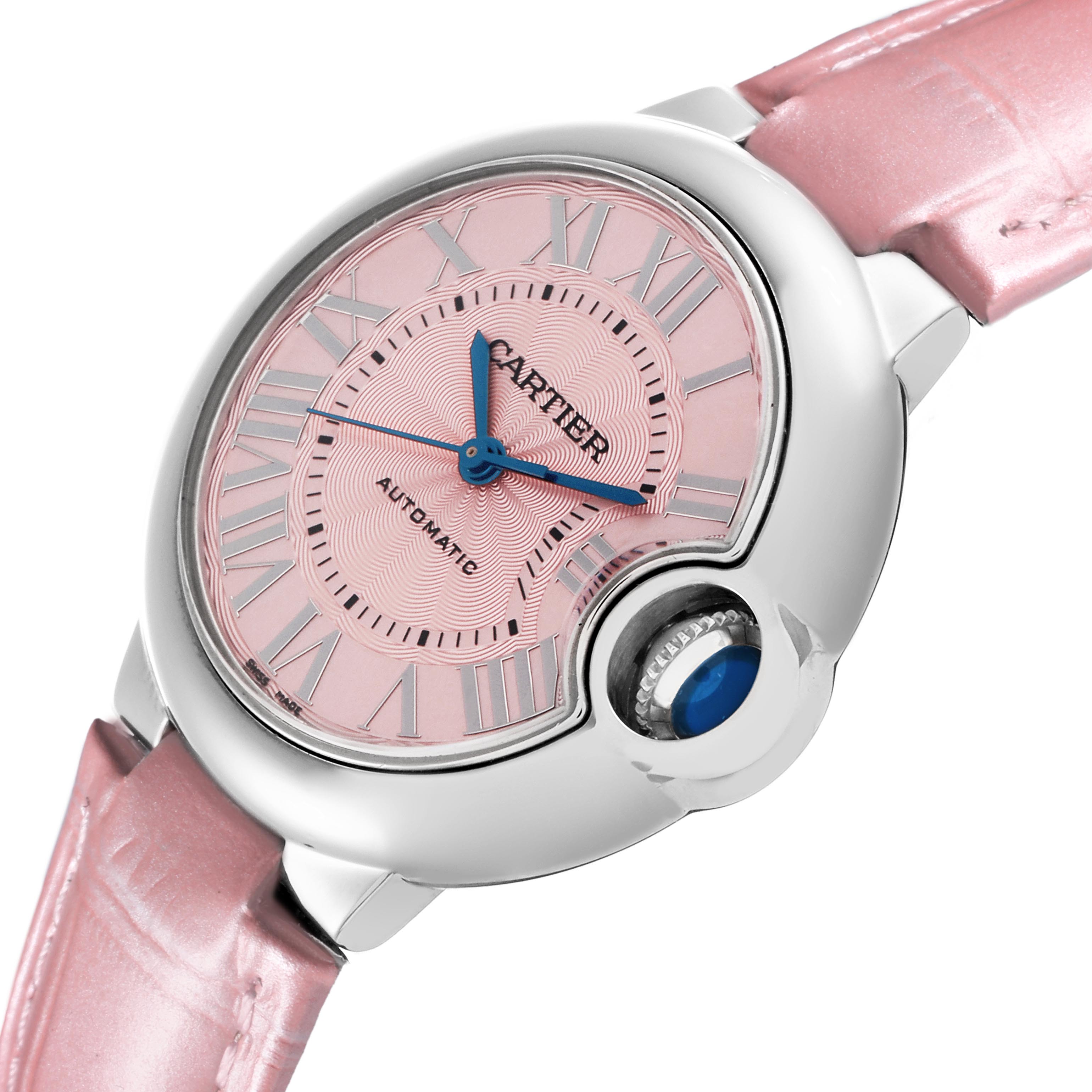 The Cartier Ballon Bleu WSBB0002 Women's Stainless Steel Pink Dial WSBB0002 Women's Stainless Steel Pink Dial watch is shown at an angle highlighting the pink dial, Roman numerals, and the distinctive crown.