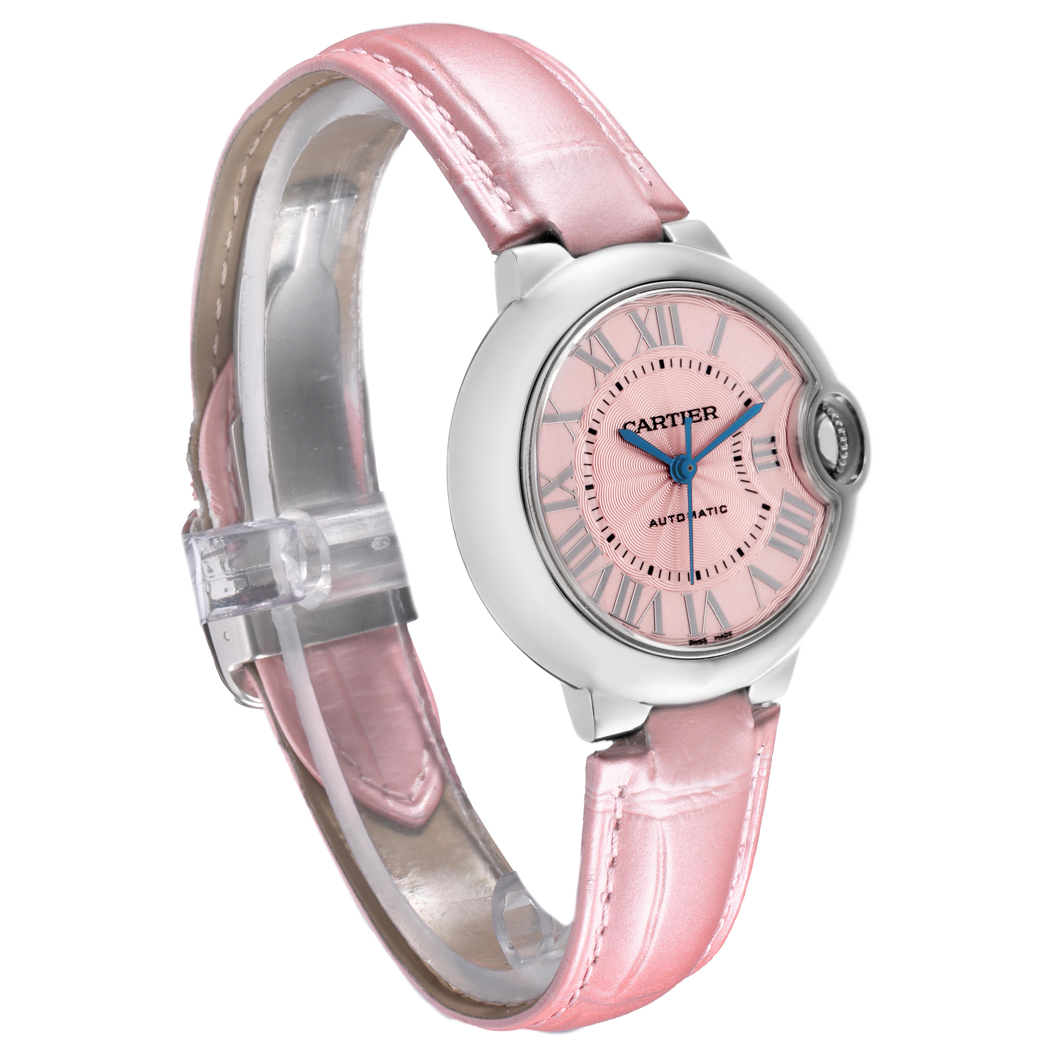 The Cartier Ballon Bleu WSBB0002 Women's Stainless Steel Pink Dial WSBB0002 Women's Stainless Steel Pink Dial watch is shown at a three-quarter angle, displaying its pink dial, blue hands, and pink leather strap.