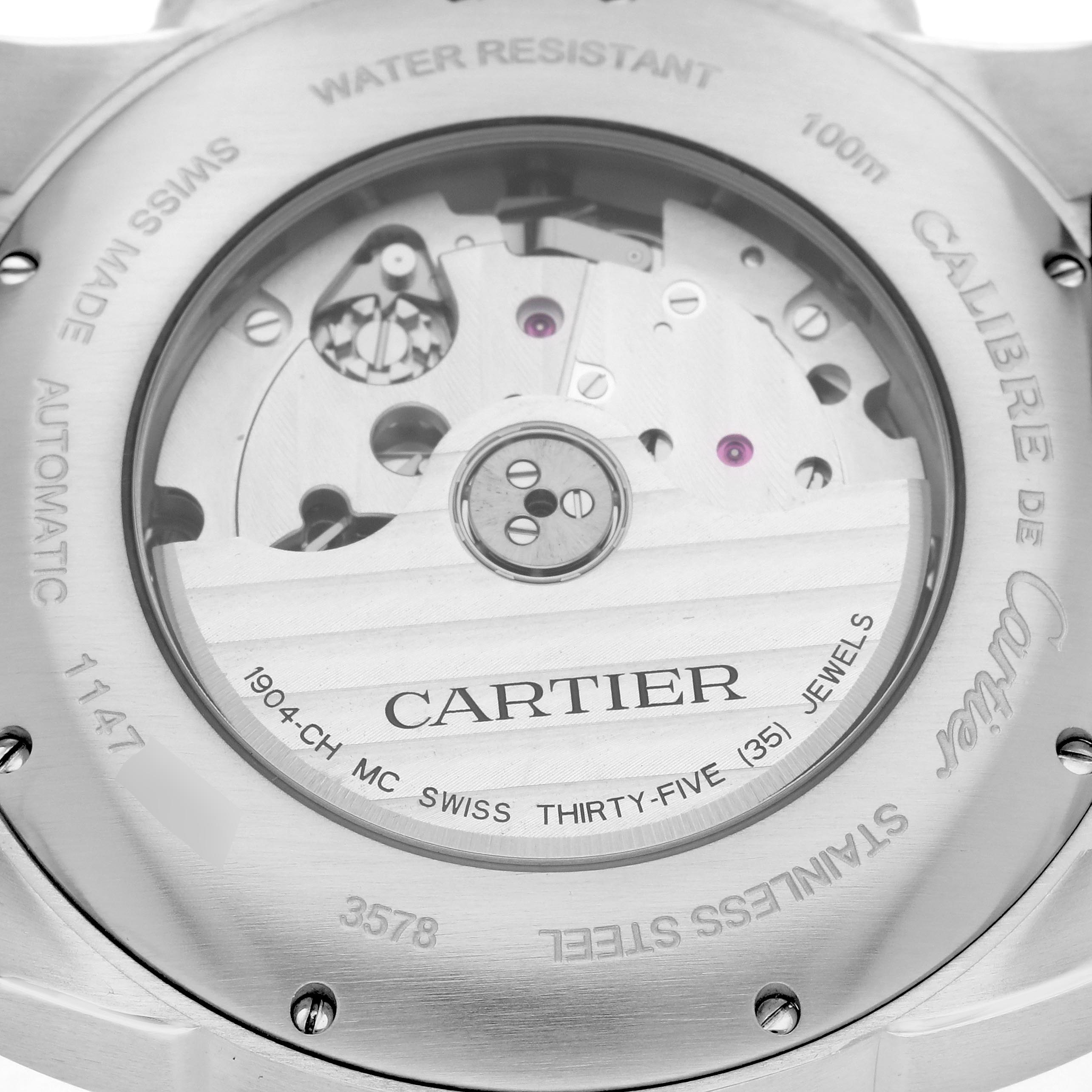 The image shows the back view of the Calibre de Cartier watch, highlighting its automatic movement and inner workings through the transparent case back.