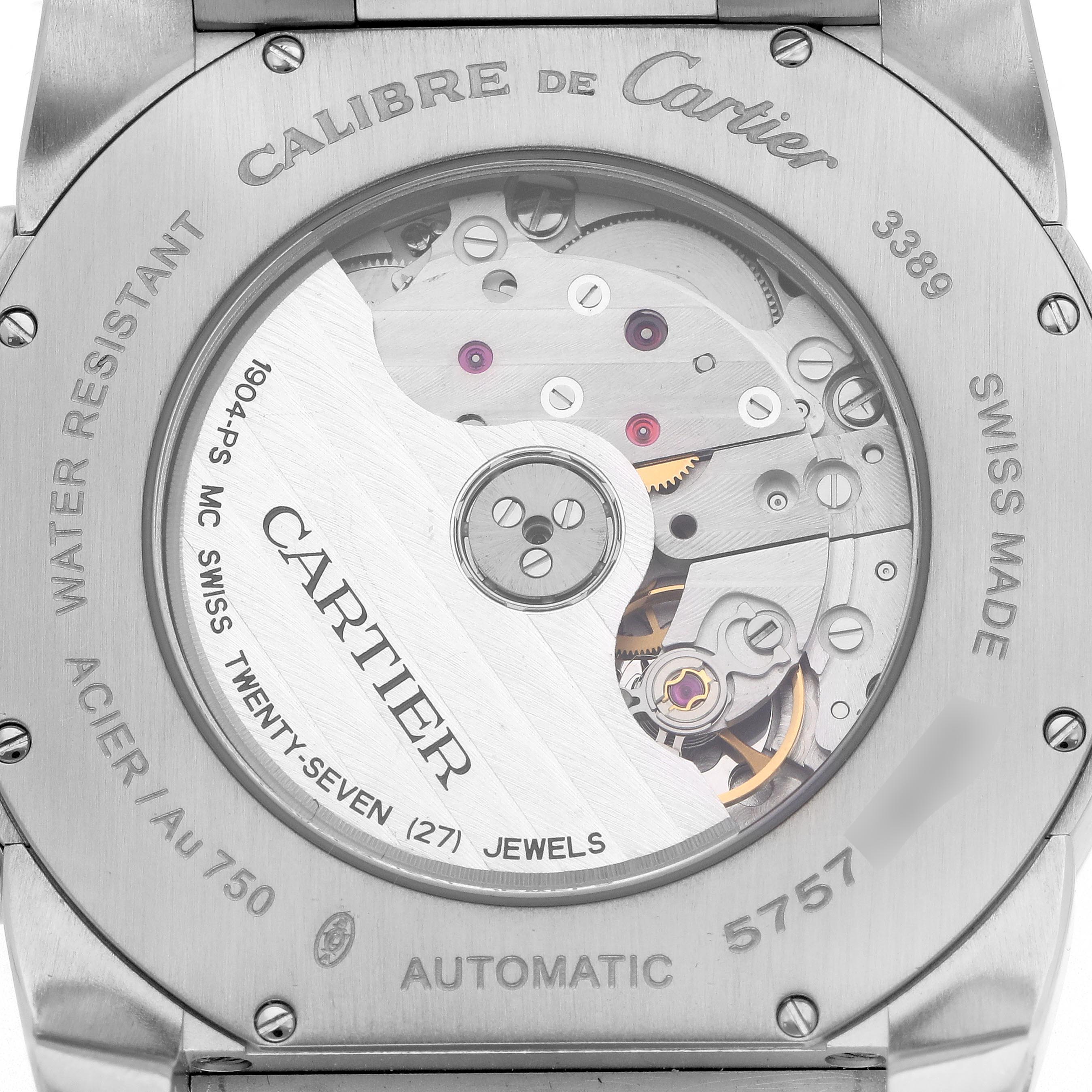 The image shows the back view of a Calibre de Cartier watch, highlighting its automatic movement and internal components.