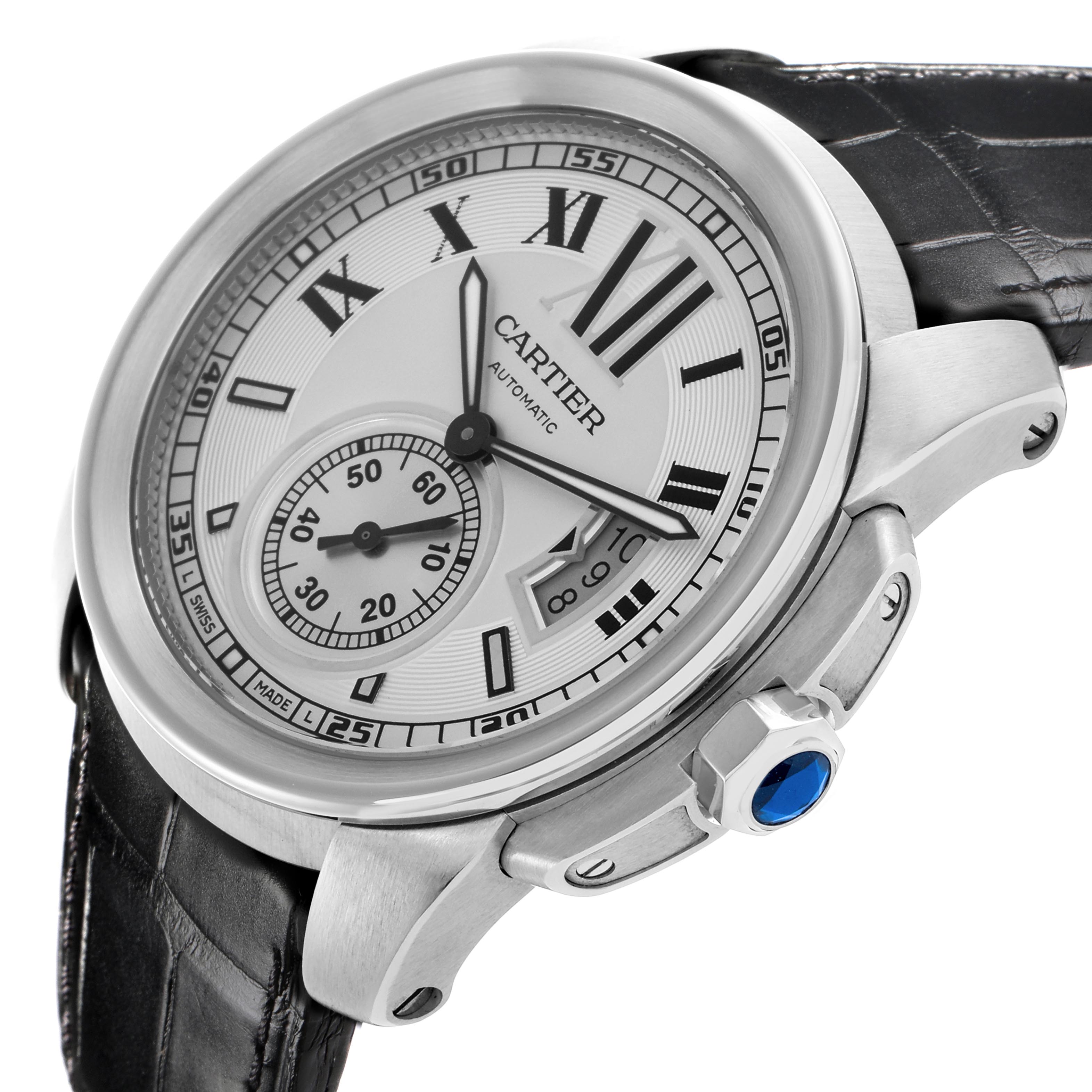 The Calibre de Cartier watch is shown from a side angle, highlighting the dial, case, crown with blue gem, and part of the strap.