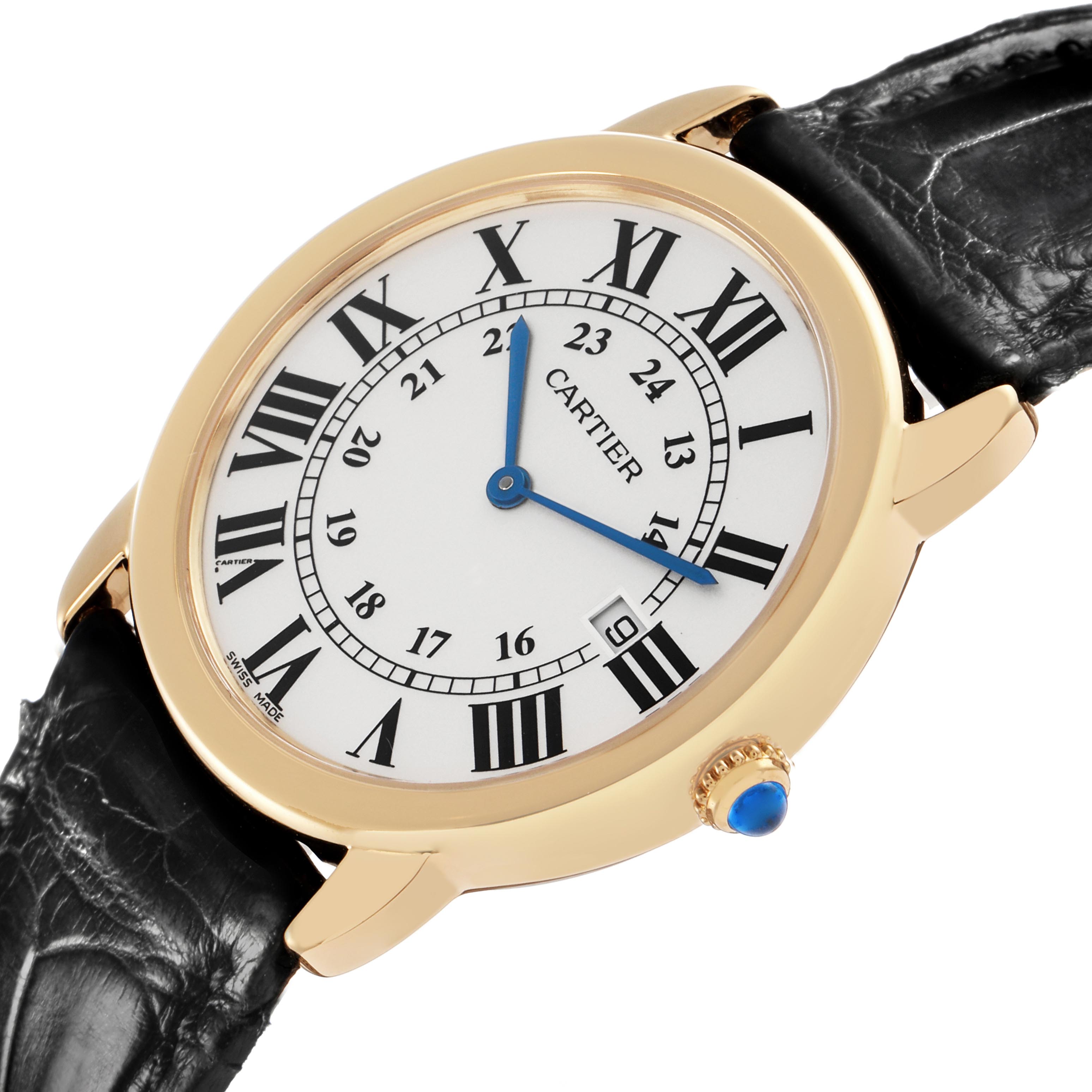 The Cartier Ronde W6700455 Men
s Yellow Gold Silver Dial W6700455 Men
s Yellow Gold Silver Dial watch is shown at a slight angle, highlighting the face, Roman numerals, gold bezel, and black leather strap.