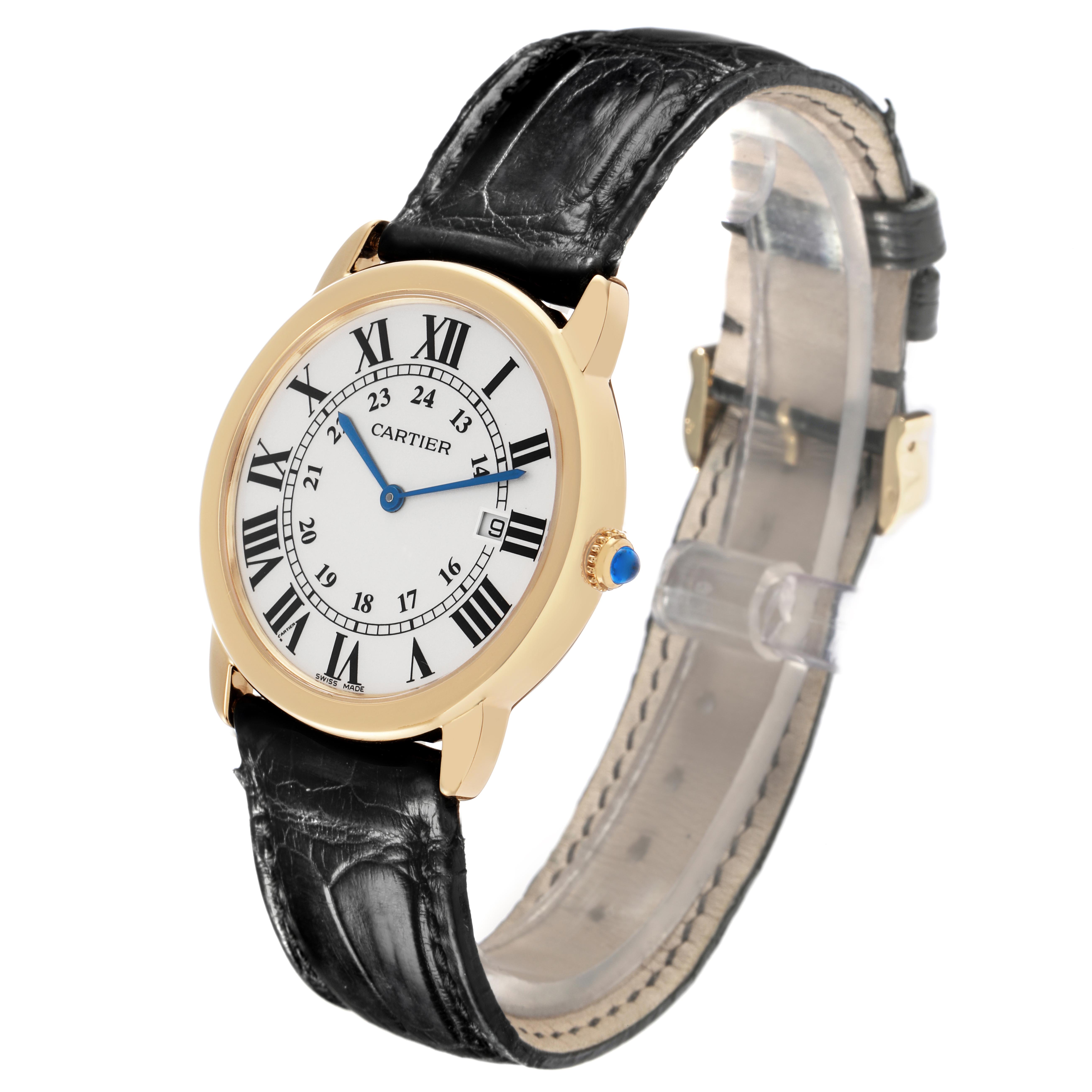 This image shows a Cartier Ronde W6700455 Men
s Yellow Gold Silver Dial W6700455 Men
s Yellow Gold Silver Dial watch at an angled view, displaying its face, gold casing, blue hands, and black leather strap.