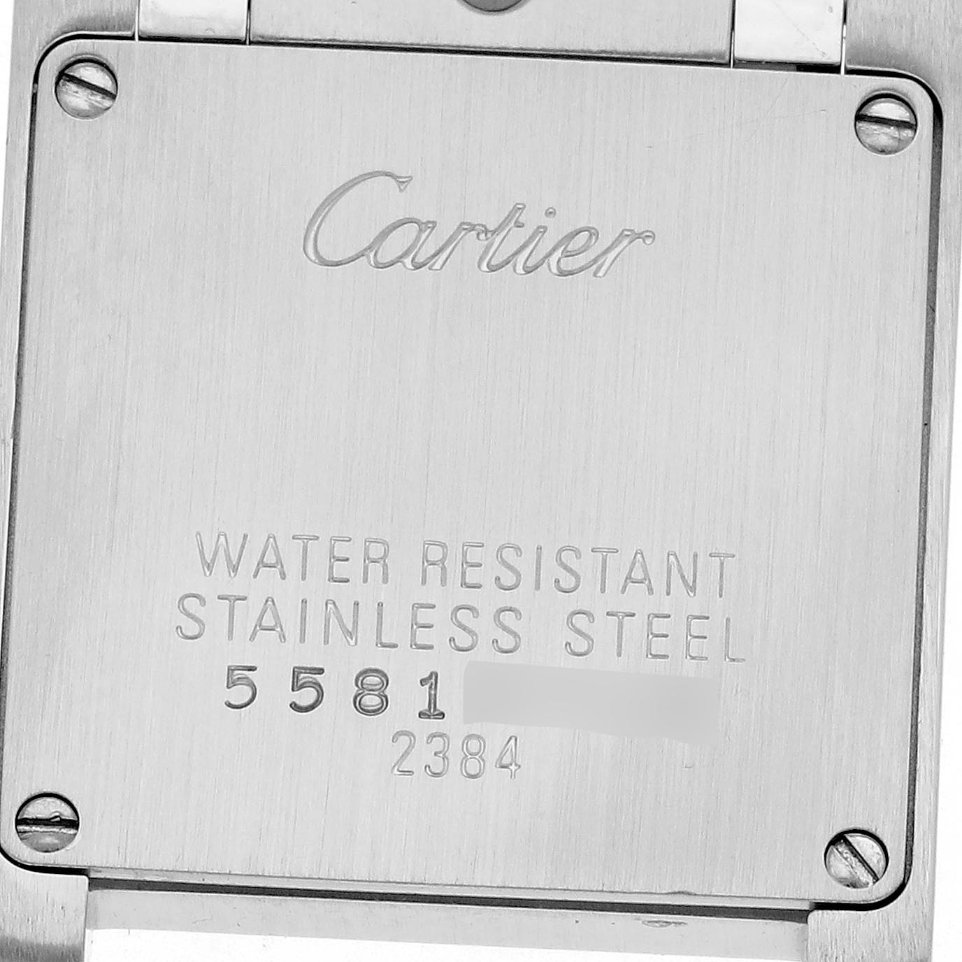 The image shows the case back of a Cartier Tank Française, highlighting its stainless steel construction and model details.