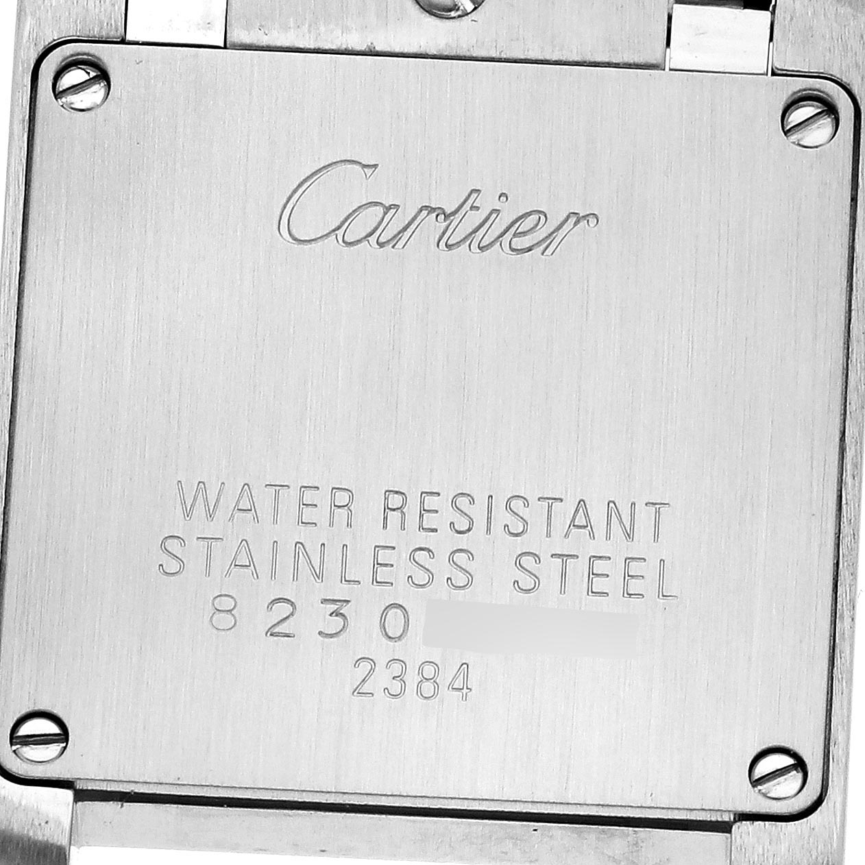 The image shows the back case of a Cartier Tank Française, highlighting its stainless steel detail.