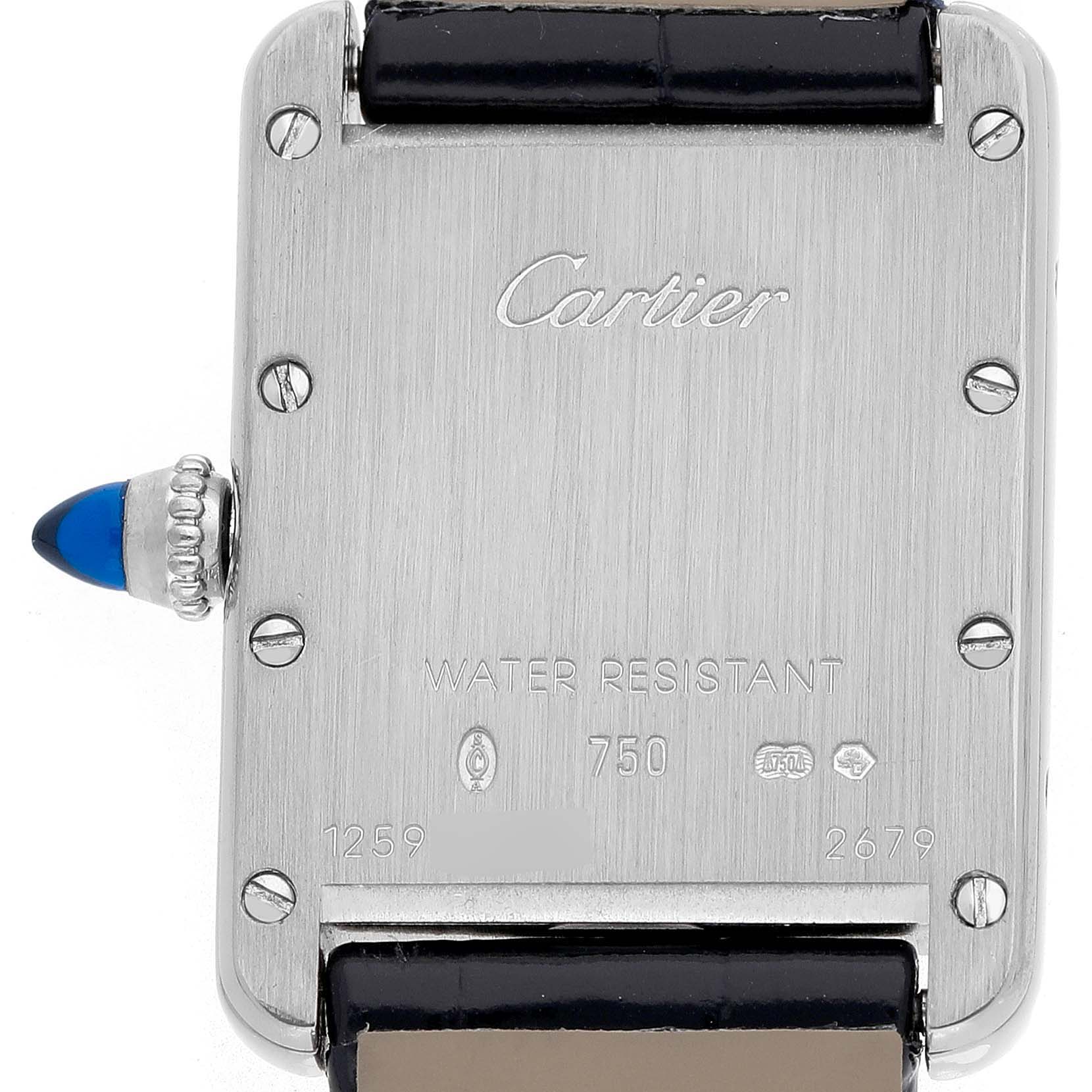 The image shows the back of a Cartier Tank Louis W1541056 Women's White Gold Silver Dial watch, highlighting the caseback, screws, and crown with a blue cabochon.
