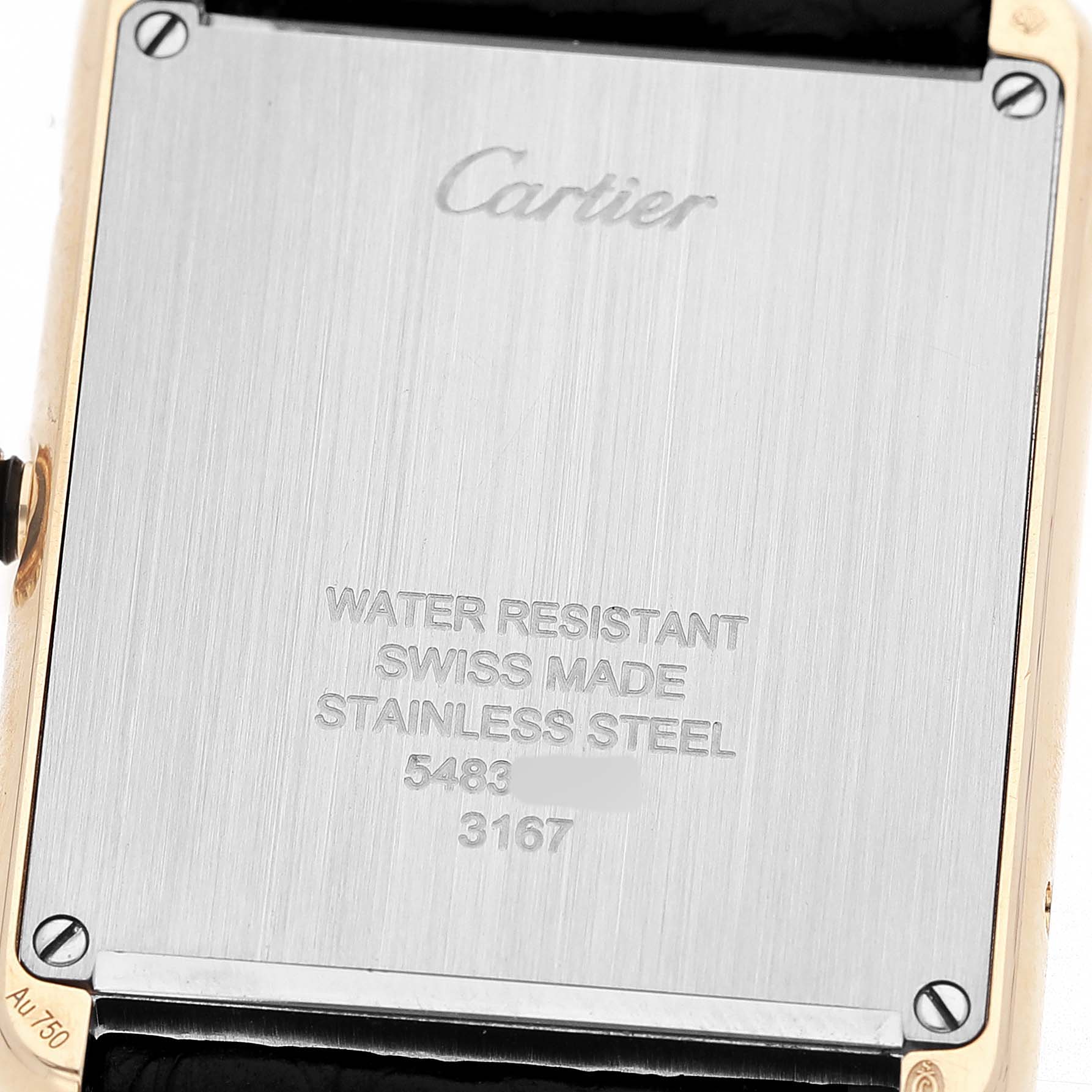 The image shows the back casing of the Cartier Tank Solo W5200004 Men's Yellow Gold Silver Dial watch, featuring engraved details and a visible band edge.