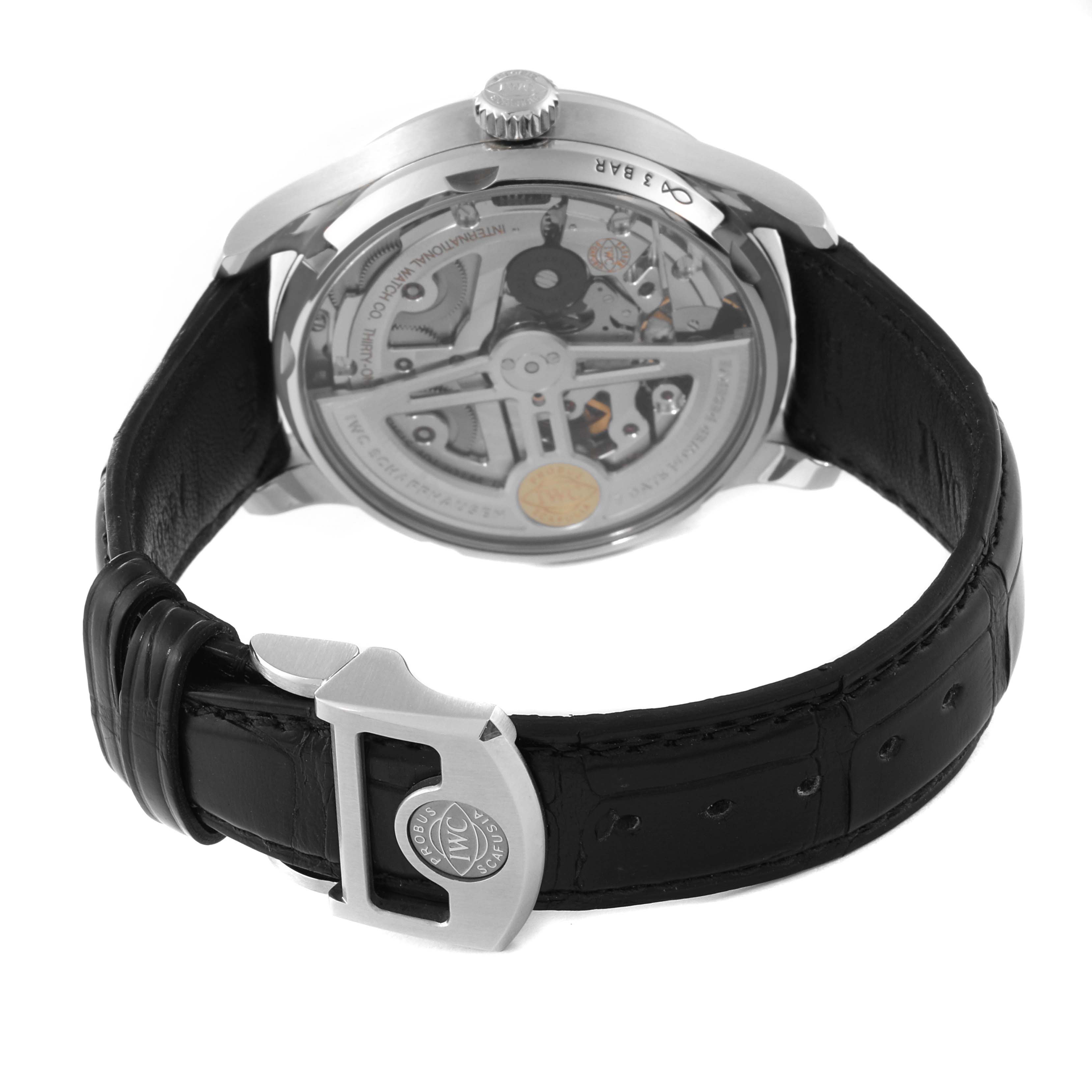 The image shows the back view of the IWC Portuguese IW500703 Men's Stainless Steel Black Dial IW500703 Men's Stainless Steel Black Dial watch, exposing the movement and detailing the strap and clasp.