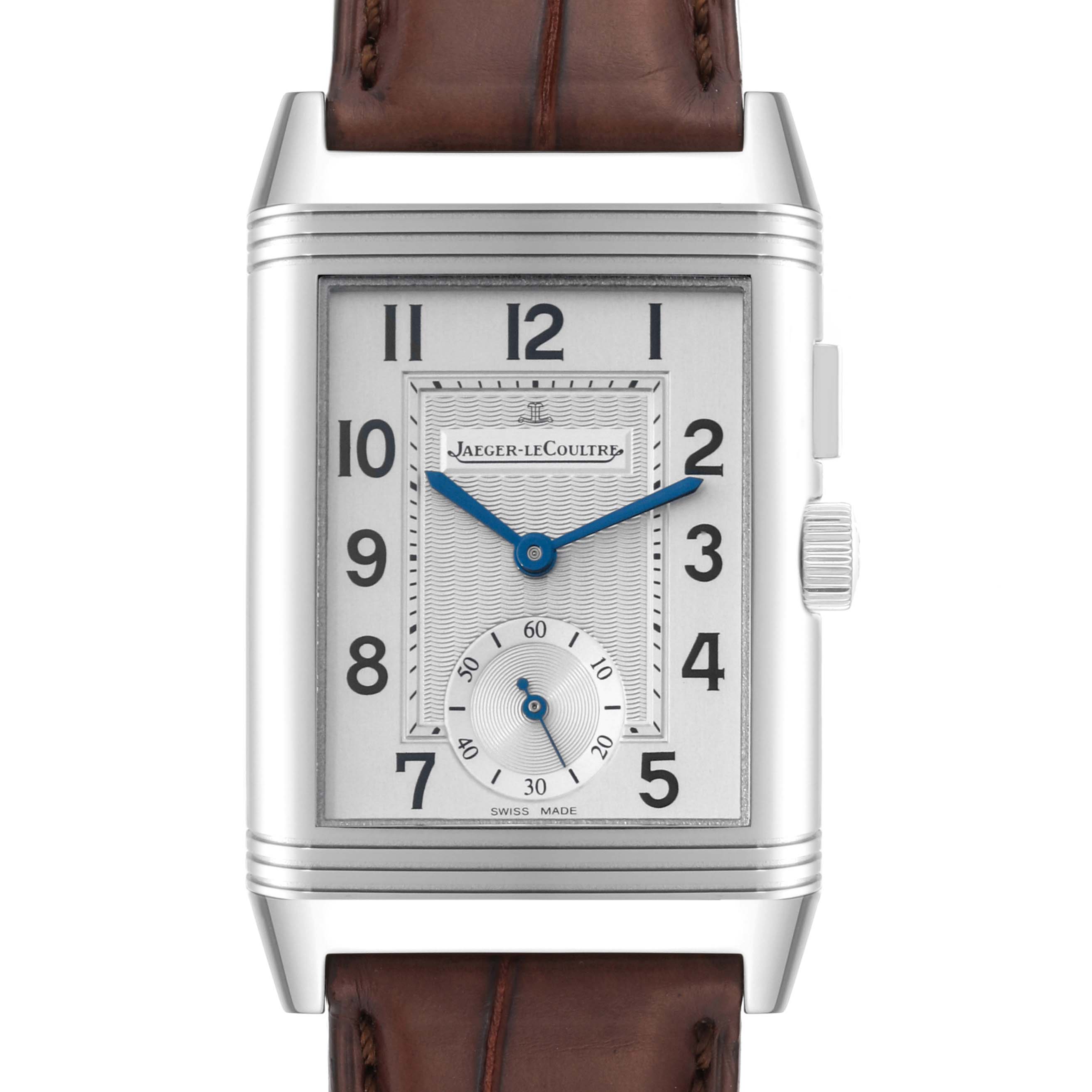The image shows a front view of a Reverso model watch by Jaeger LeCoultre, highlighting its rectangular face, dial, and leather strap.
