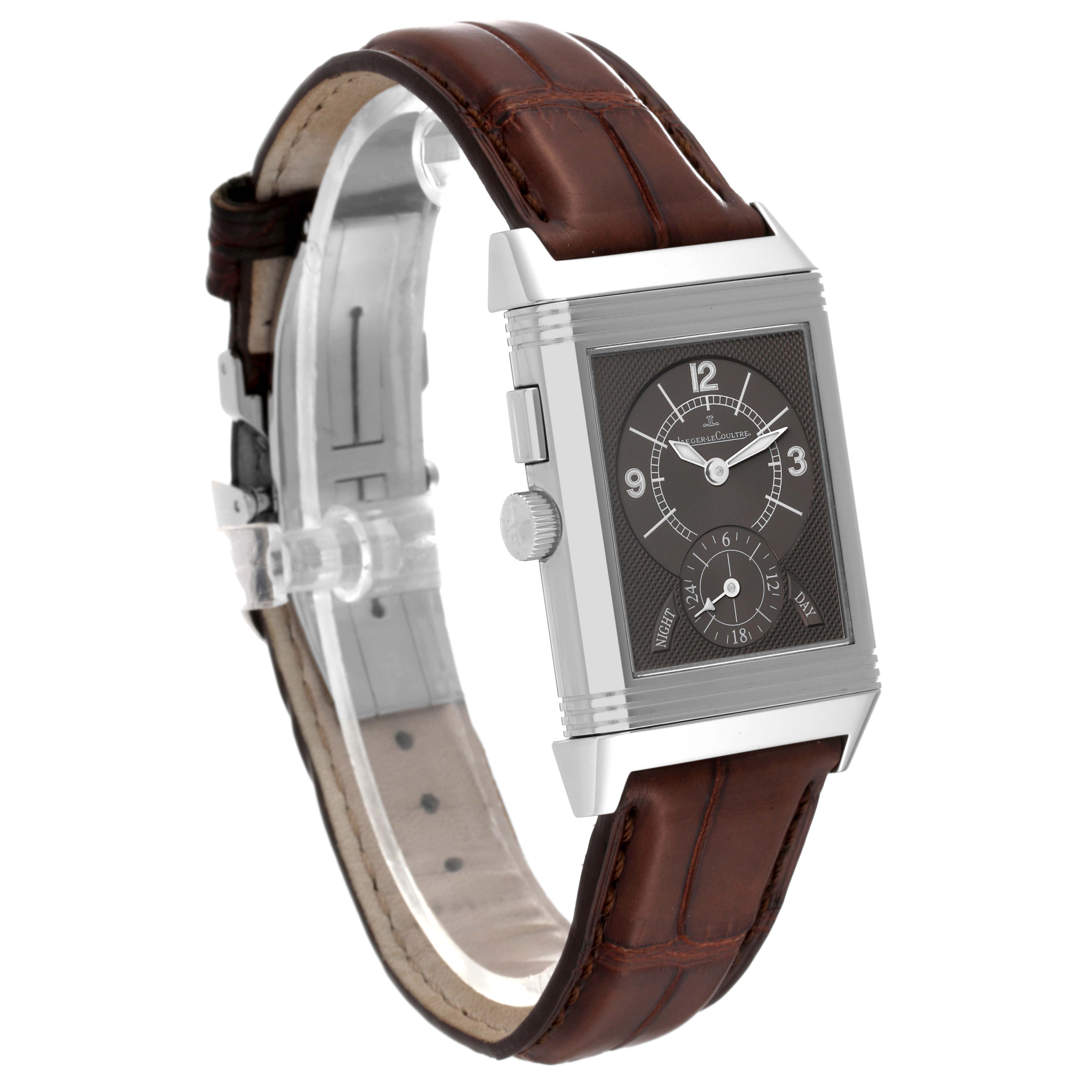 This image shows a Jaeger LeCoultre Reverso Q2718410 Men
s Stainless Steel Silver Dial Q2718410 Men
s Stainless Steel Silver Dial watch from a slight side angle, highlighting the face, crown, and brown leather strap.