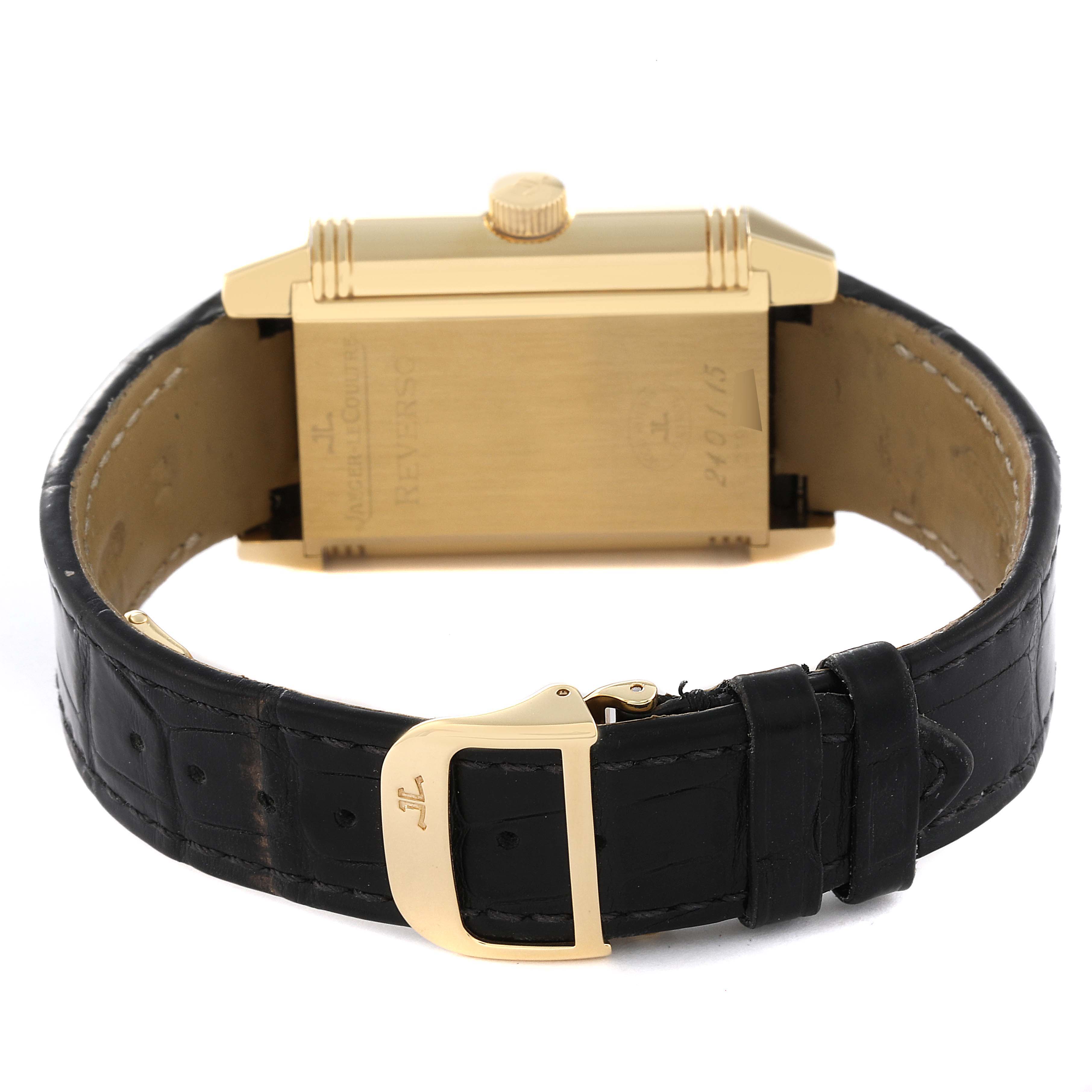 This image shows a Jaeger LeCoultre Reverso Q3001420 Men's Yellow Gold Silver Dial Q3001420 Men's Yellow Gold Silver Dial watch from the back, highlighting the clasp and leather strap.
