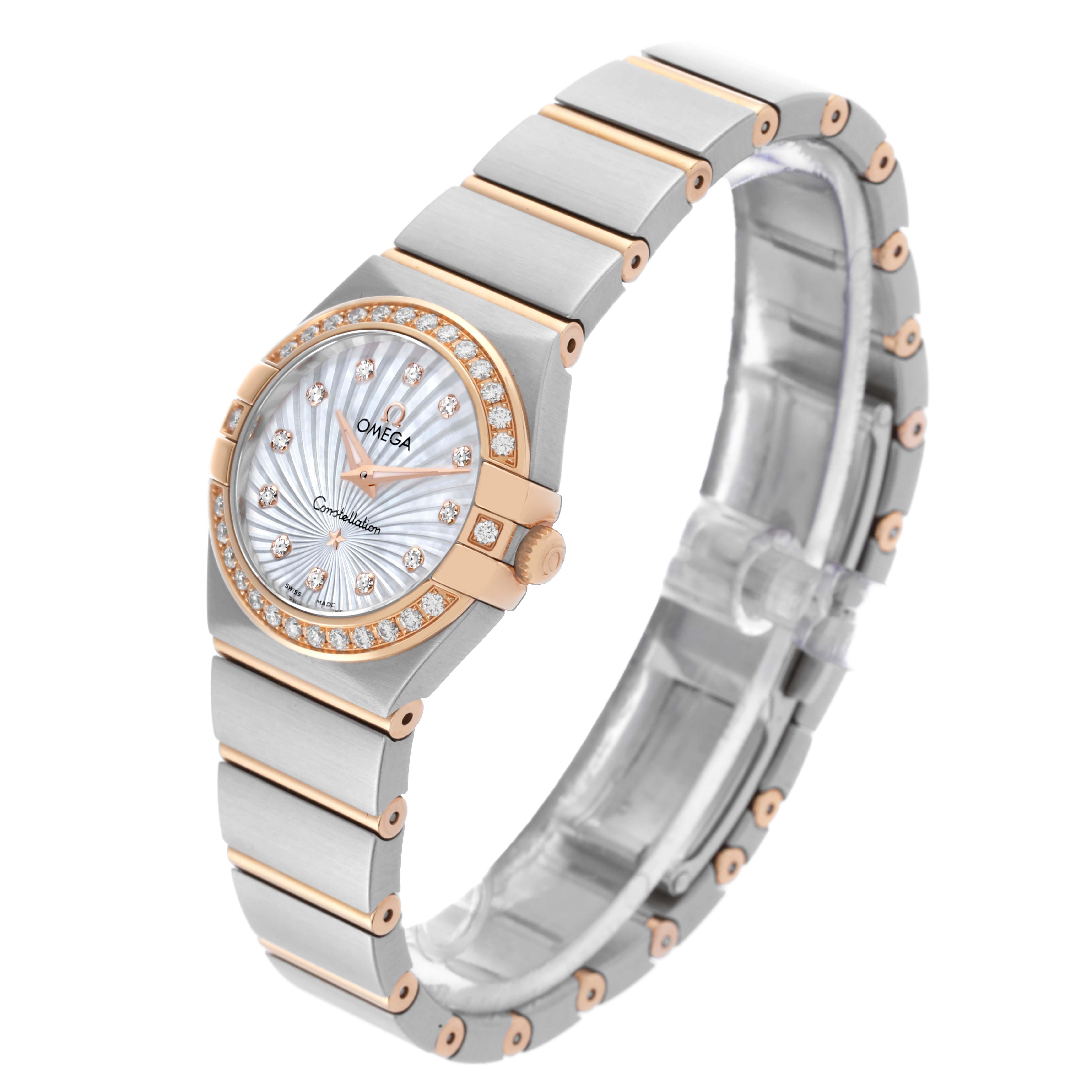 The Omega 123.25.24.60.55.002 Women's Steel and Gold (two tone) Mother of Pearl Dial 123.25.24.60.55.002 Women's Steel and Gold (two tone) Mother of Pearl Dial Constellation Steel Rose Gold Diamond Watch 123.25.24.60.55.002 is shown at an angle displaying the face, bezel, and bracelet.