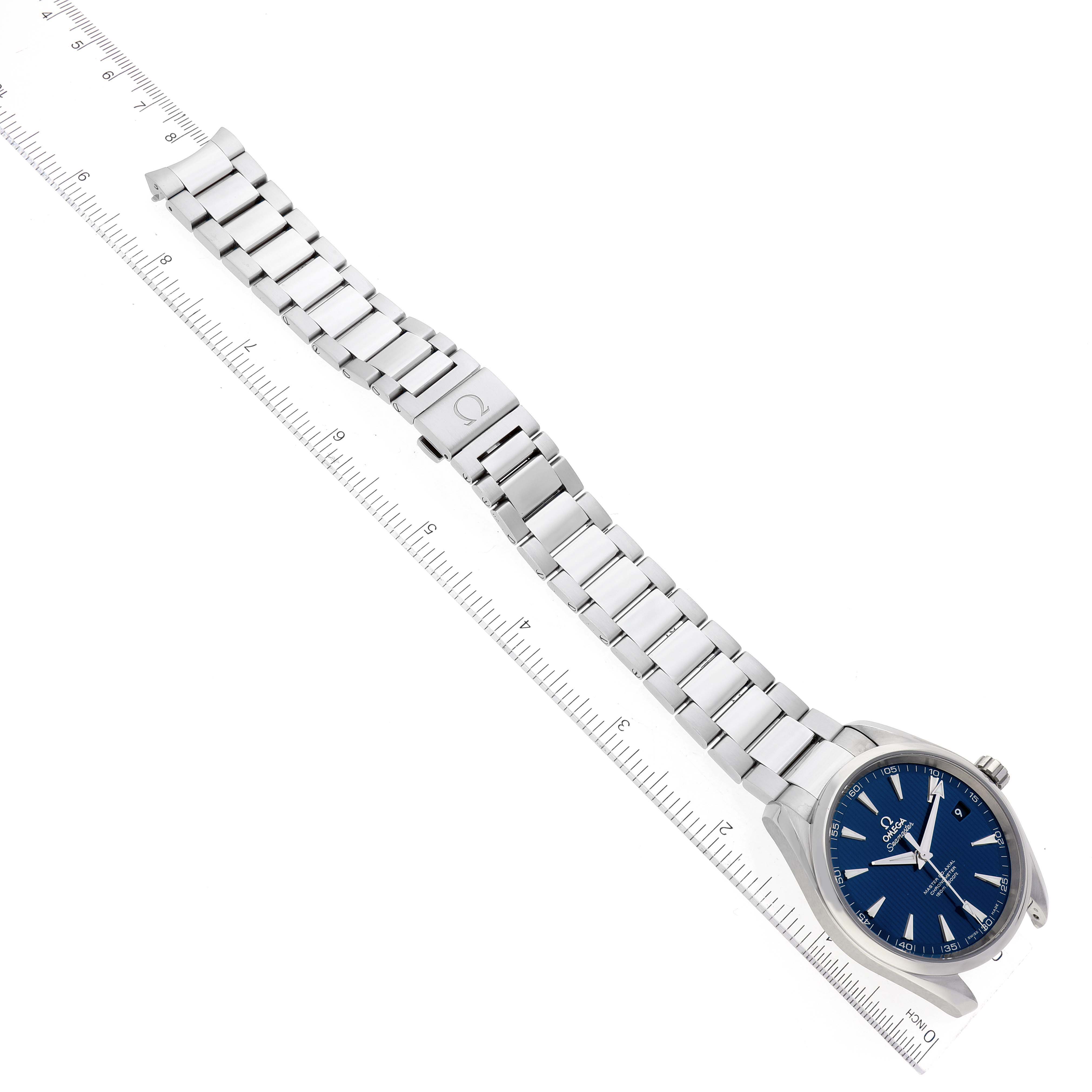 The Omega Seamaster 231.10.42.21.03.003 Men's Stainless Steel Blue Dial 231.10.42.21.03.003 Men's Stainless Steel Blue Dial watch is displayed at an angle, highlighting its blue dial, stainless steel bracelet, and clasp, alongside a ruler for scale.