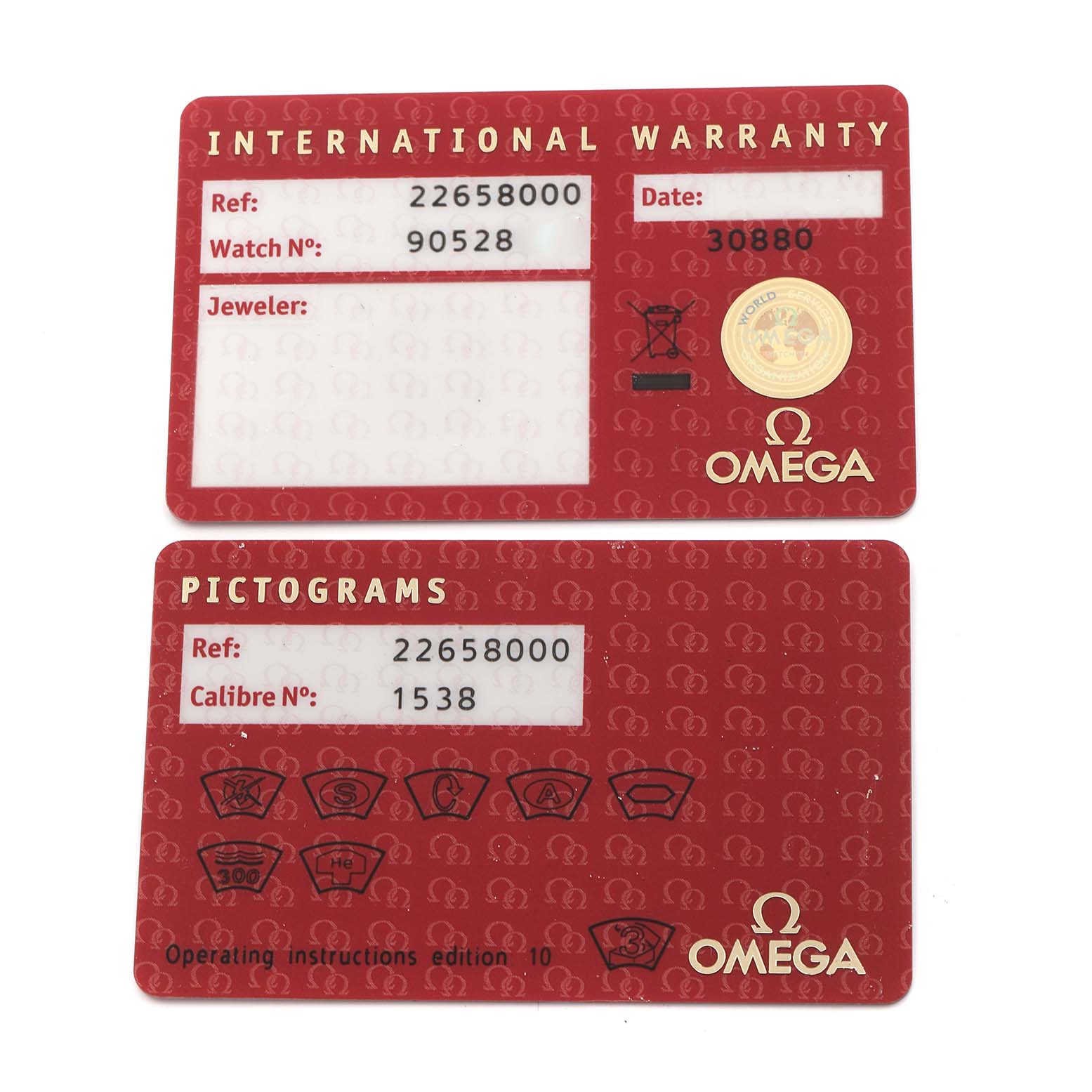 The image shows top views of two red cards for the Omega Seamaster 2265.80.00 Men
s Stainless Steel Blue Dial 2265.80.00 Men
s Stainless Steel Blue Dial: an International Warranty and a Pictograms card.