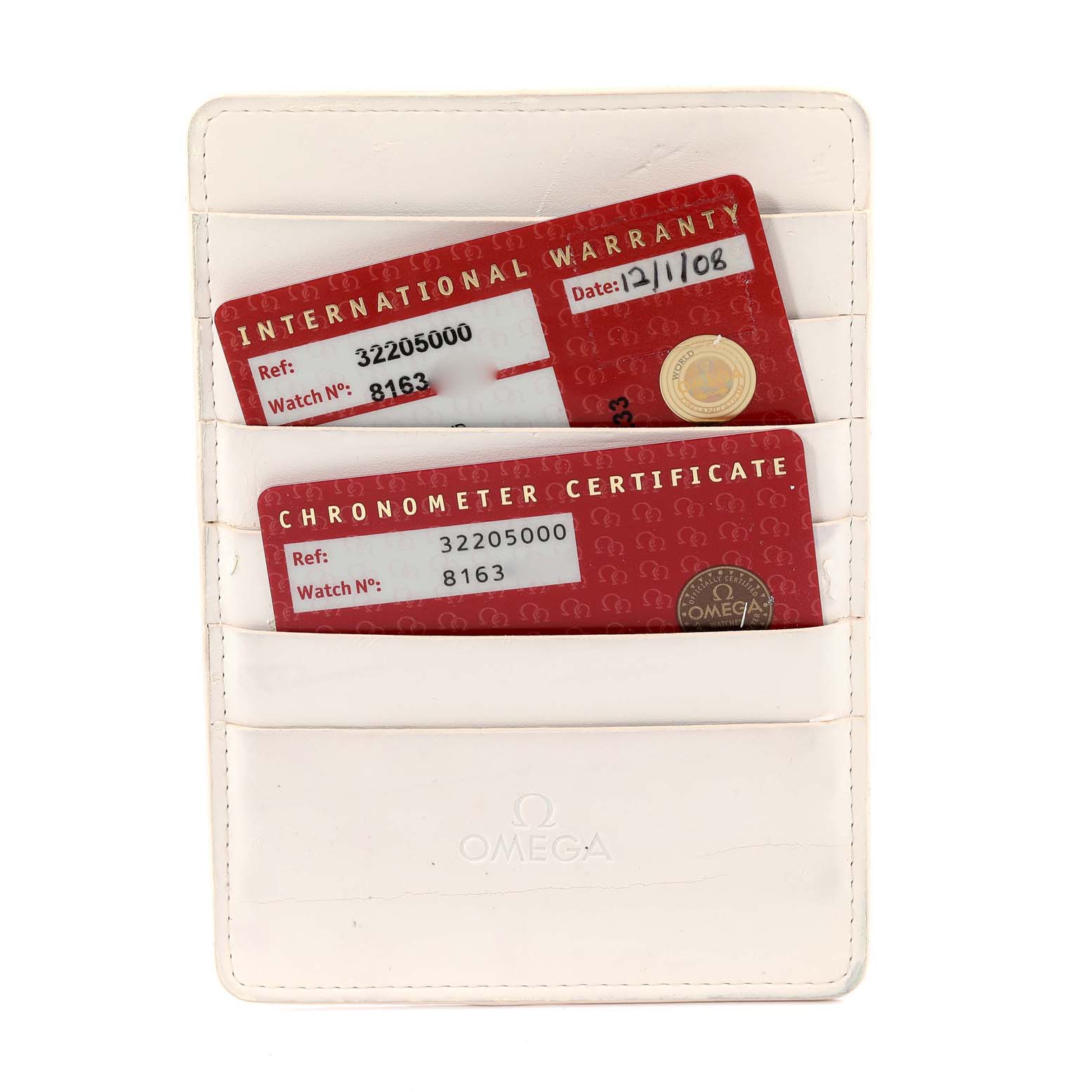 The image shows an Omega Speedmaster 3220.50.00 Men's Stainless Steel Black Dial 3220.50.00 Men's Stainless Steel Black Dial's international warranty and chronometer certificate cards in a white cardholder.