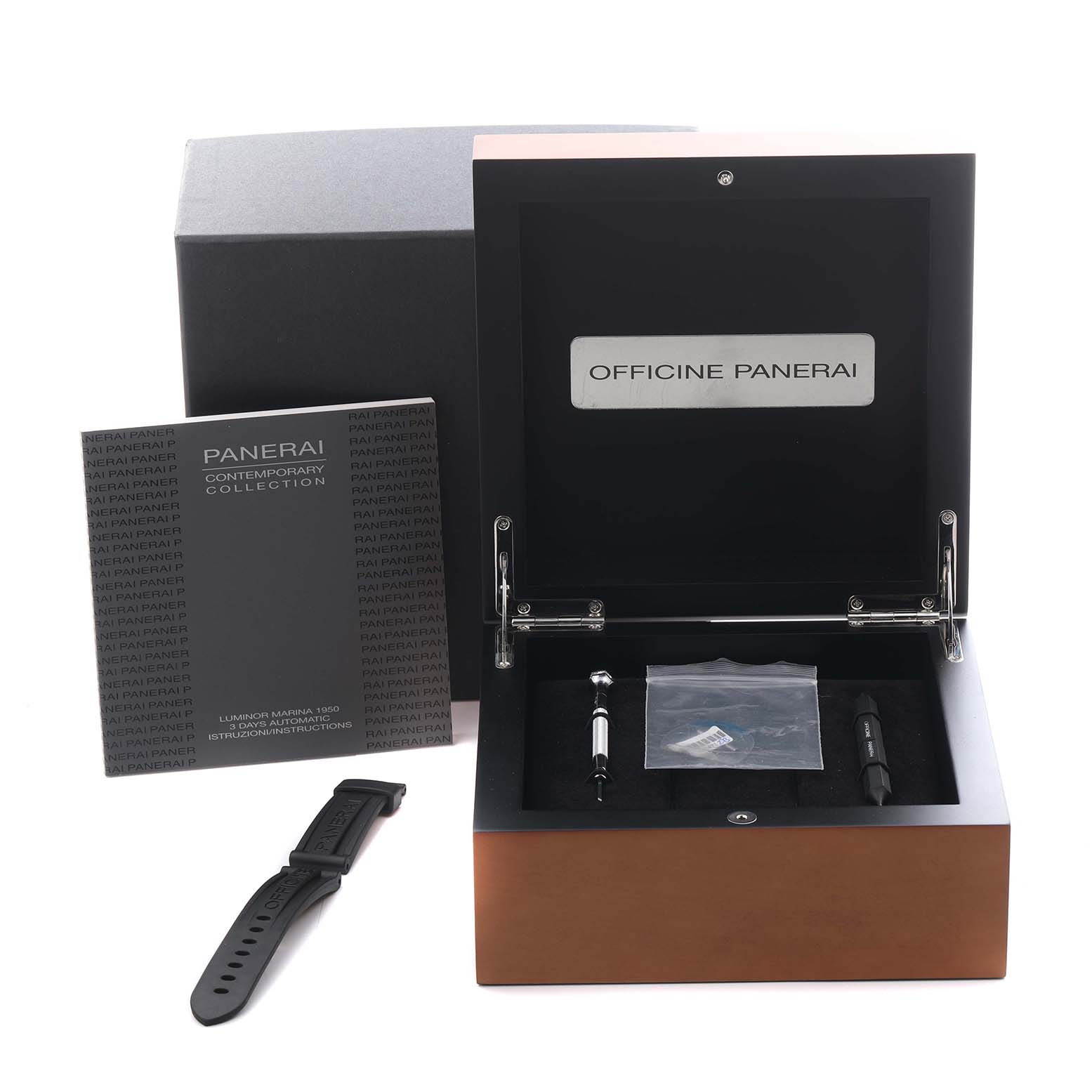 The image shows a Panerai Luminor PAM00392 Men's Stainless Steel Black Dial PAM00392 Men's Stainless Steel Black Dial watch box open, with accessories including a strap, booklet, and tools from a top angle.