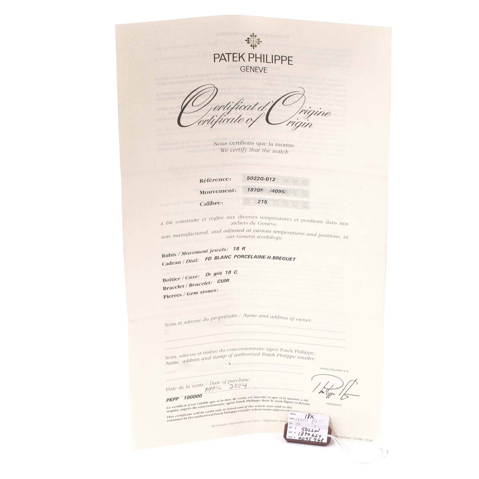 The image shows the certificate of origin and a tag for the Patek Philippe Calatrava 5022G Men's White Gold Black Dial 5022G Men's White Gold Black Dial model.