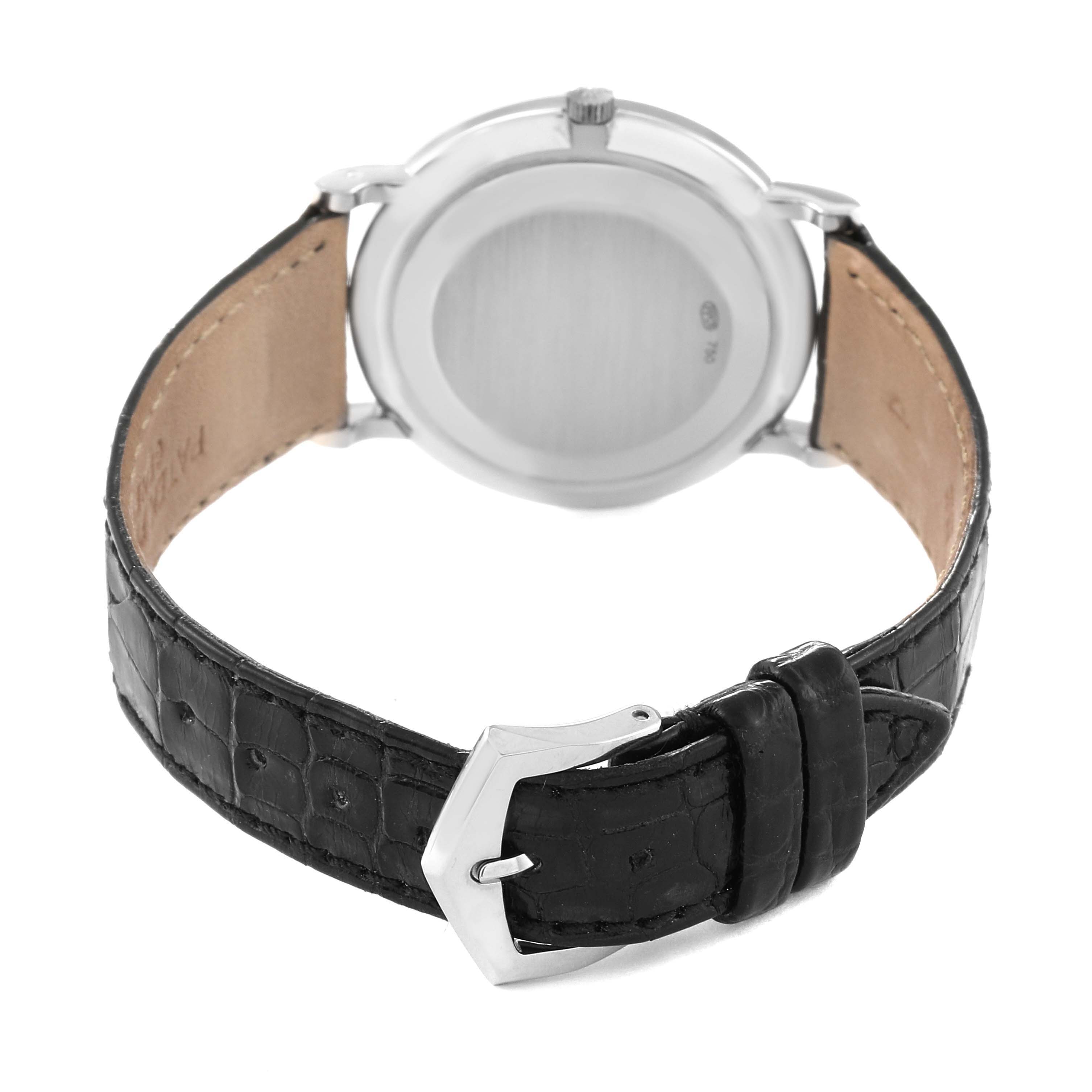 Back view of a Patek Philippe Calatrava 5022G Men's White Gold Black Dial 5022G Men's White Gold Black Dial watch showing the case back and black leather strap with a buckle.