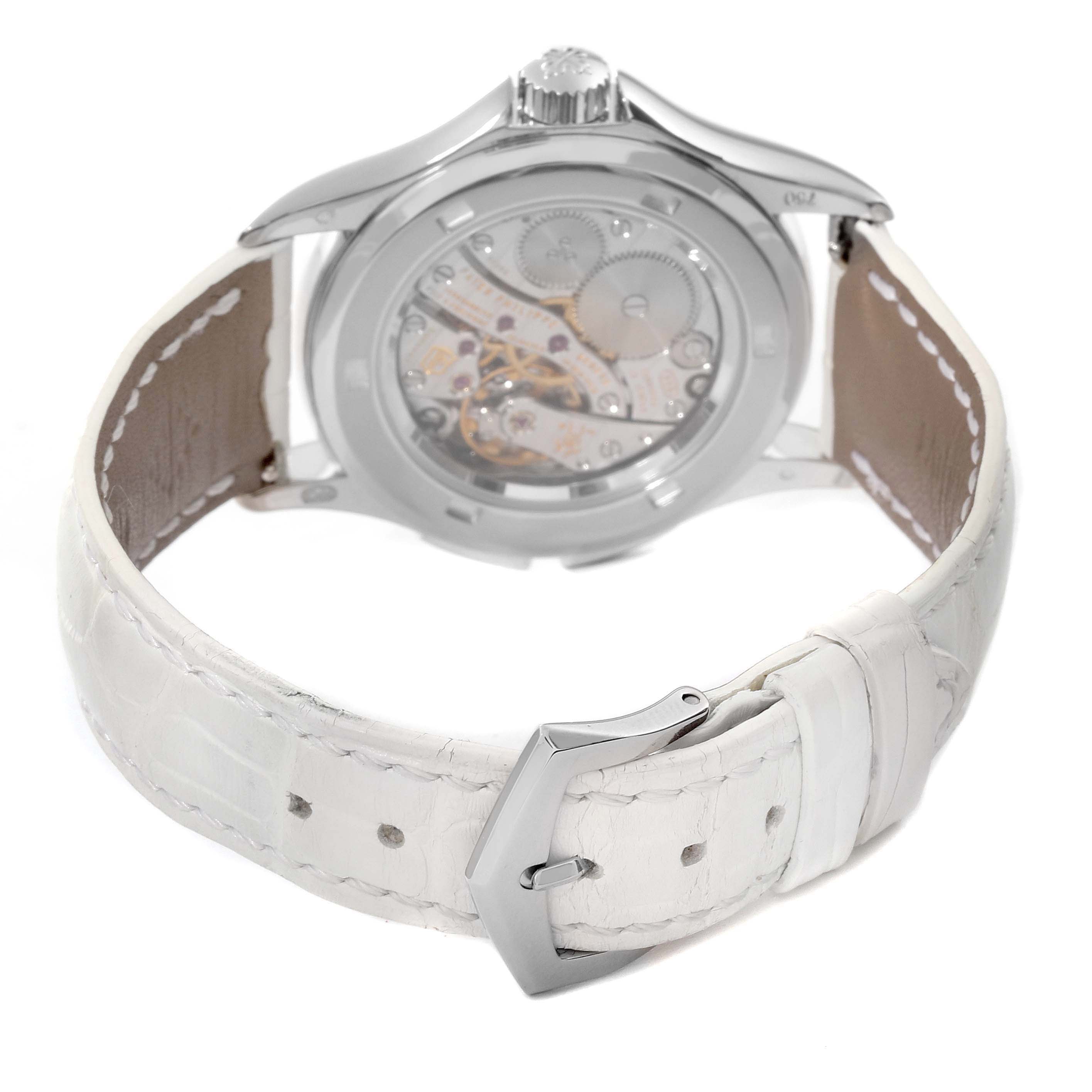 The image shows the back view of a Patek Philippe Calatrava 4934G-001 Women's White Gold Mother of Pearl Dial 4934G-001 Women's White Gold Mother of Pearl Dial watch, highlighting its movement and white leather strap.