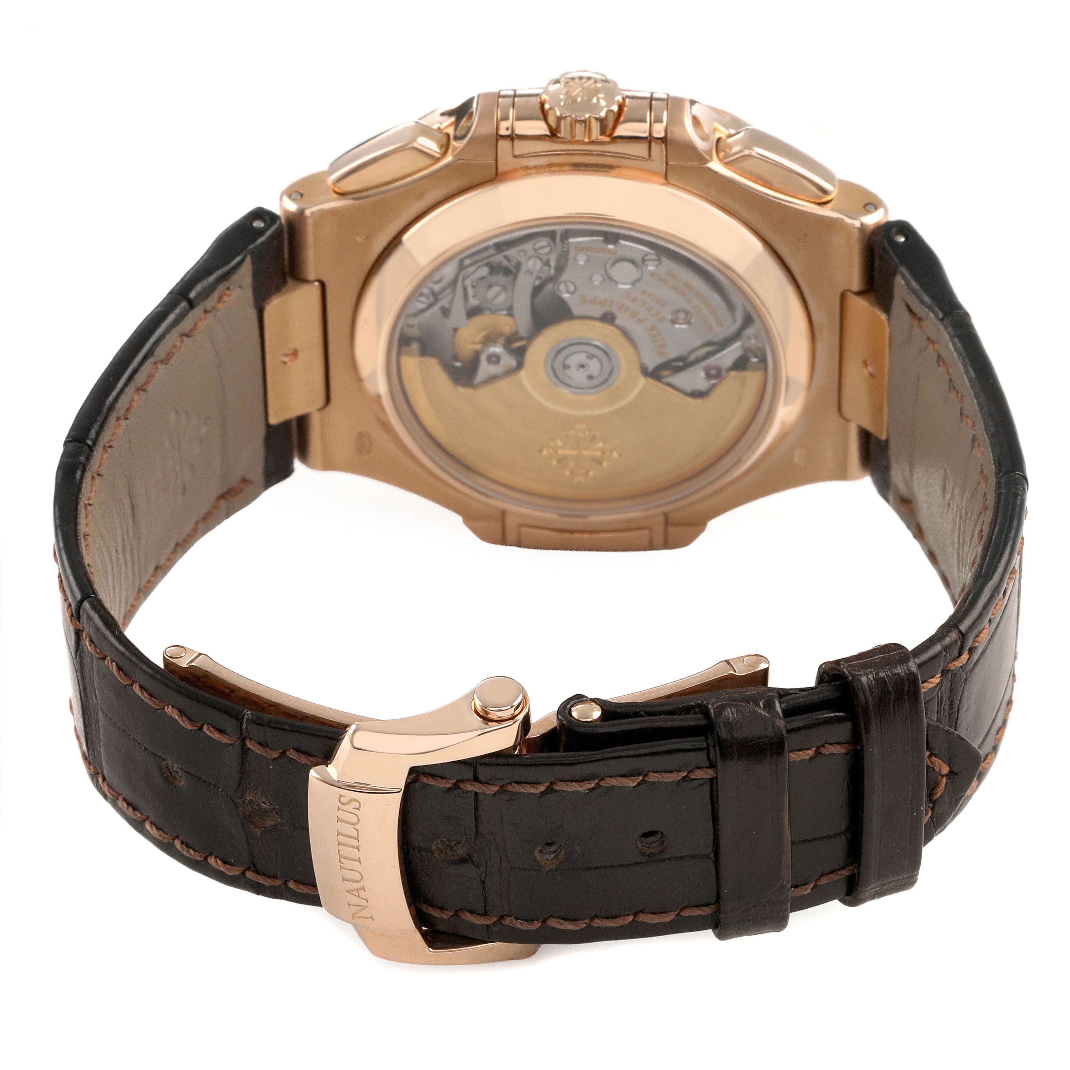 The image shows the back of a Patek Philippe Nautilus 5980R-001 Men's Rose Gold Brown Dial watch, highlighting the open case back and leather strap with a "Nautilus" clasp.