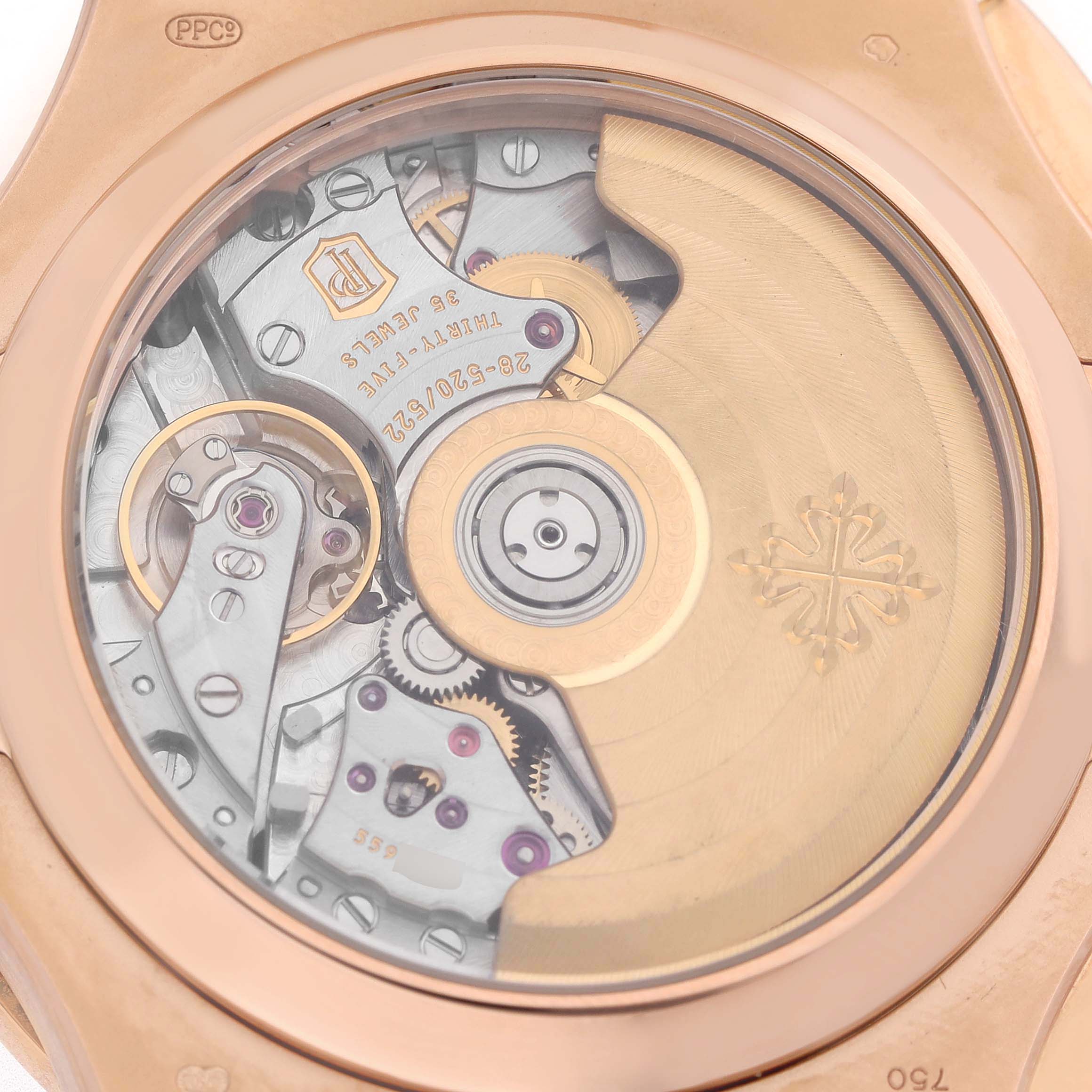 The image shows the back view of a Patek Philippe Nautilus 5980R-001 Men's Rose Gold Brown Dial watch, focusing on its intricate movement and rotor.