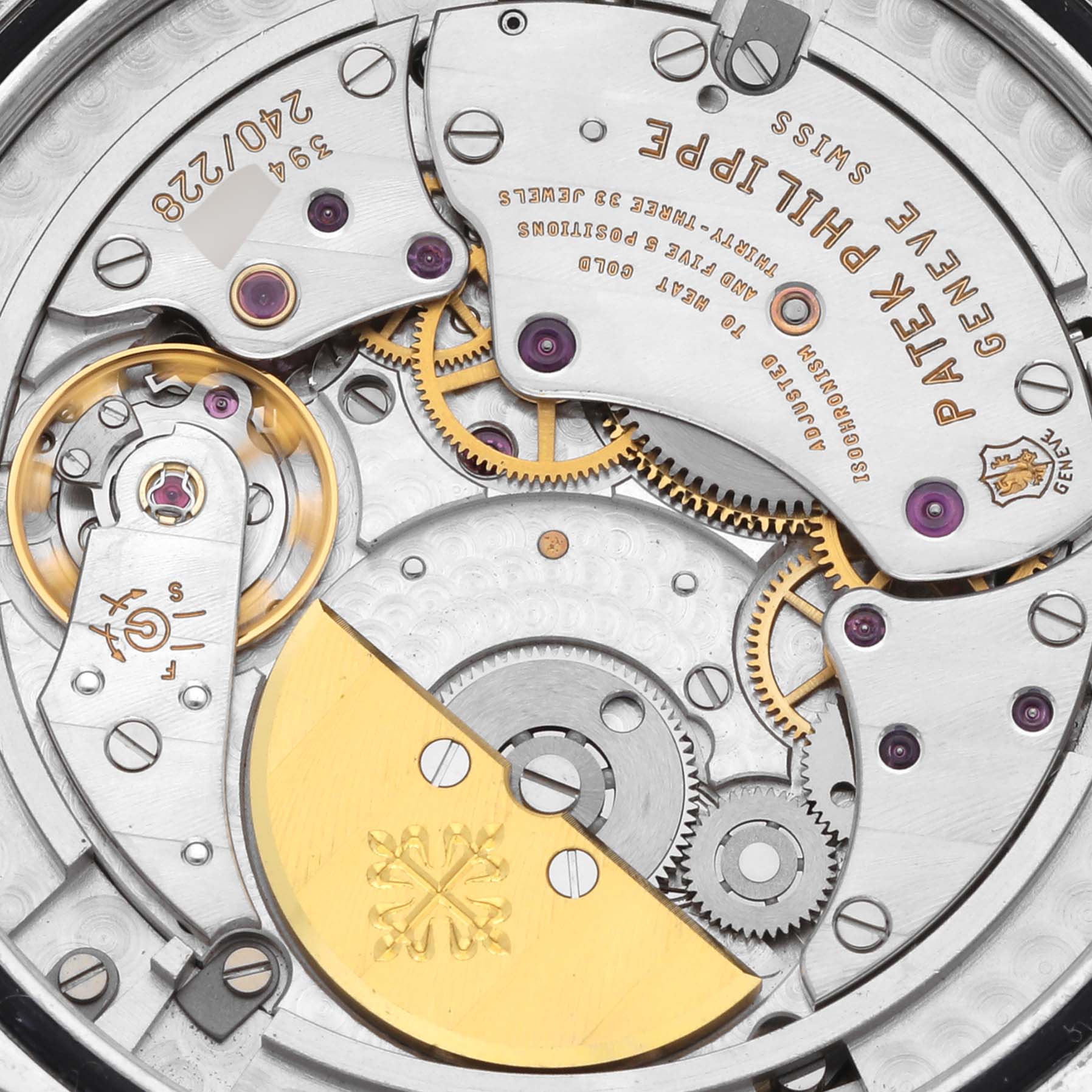 This image shows the intricate movement components of a Patek Philippe Complications 5130P-001 Men's Platinum Silver Dial 5130P-001 Men's Platinum Silver Dial watch, including gears and the rotor.