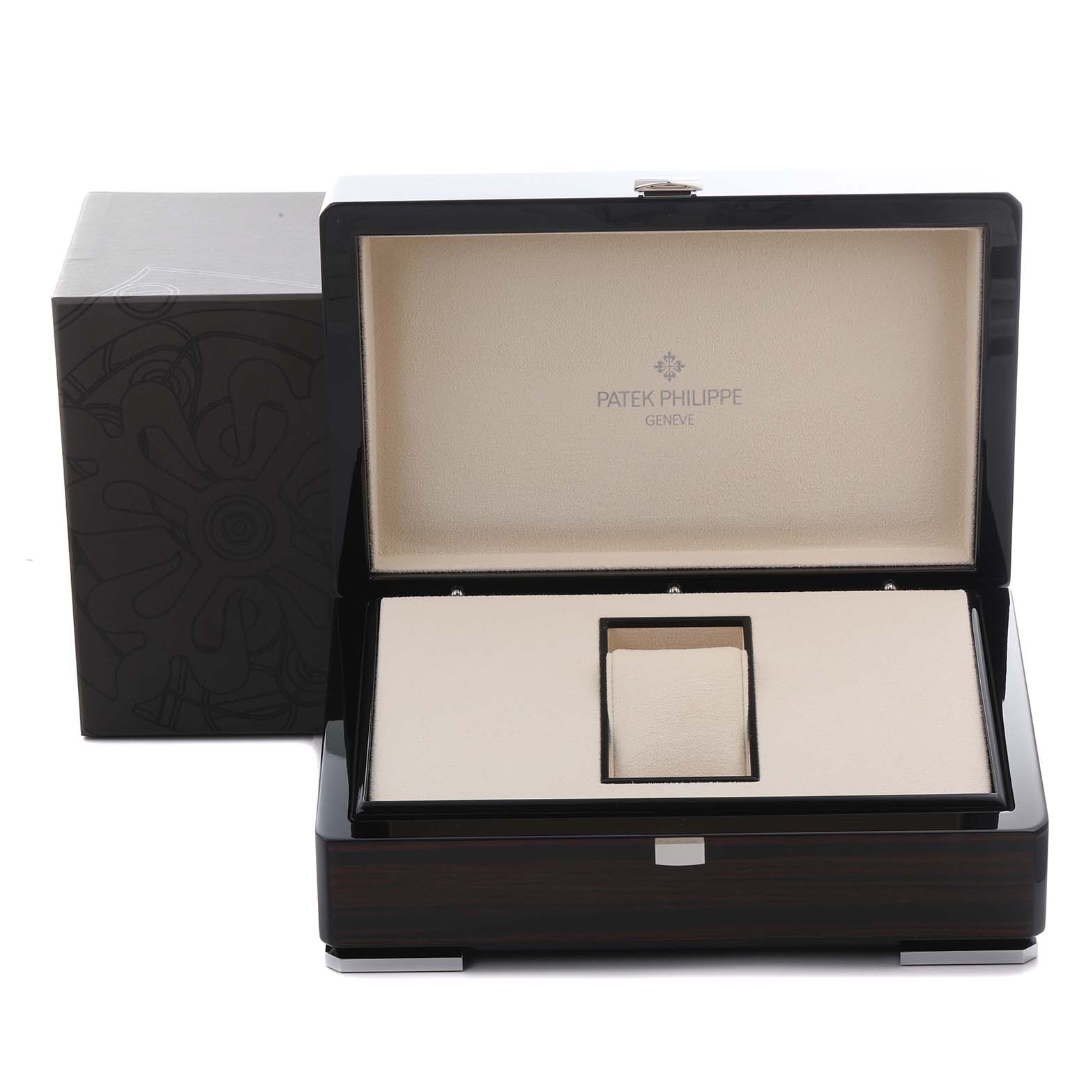 The image shows an open box for the Patek Philippe Complications 5130P-001 Men's Platinum Silver Dial 5130P-001 Men's Platinum Silver Dial watch, featuring a stand and branded interior.