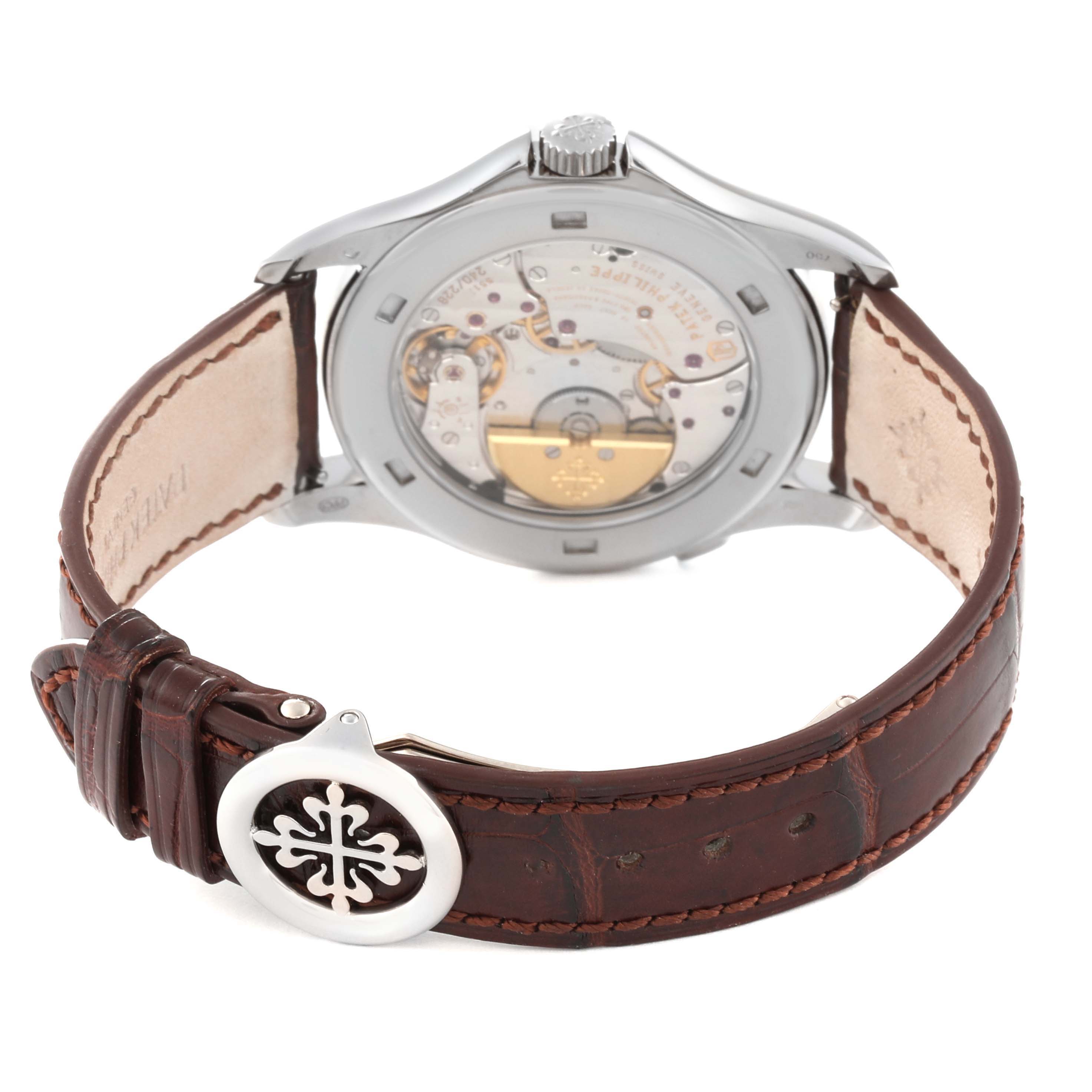 The image shows the back view of a Patek Philippe Complications 5130G-001 Men
s White Gold Silver Dial 5130G-001 Men
s White Gold Silver Dial watch, highlighting its movement and leather strap.