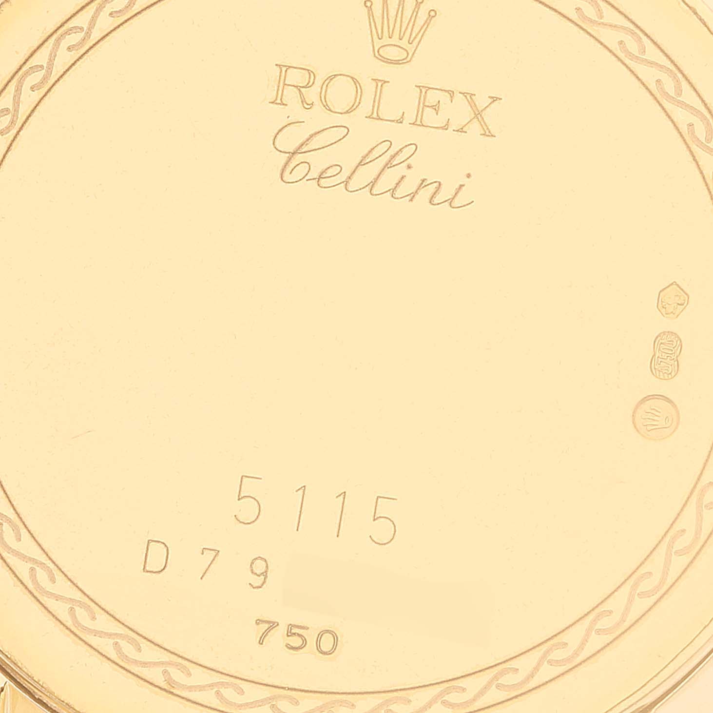 This image shows the case back of a Rolex Cellini 5115 Men's Yellow Gold Champagne Dial 5115 Men's Yellow Gold Champagne Dial model, featuring its engravings and hallmarks.