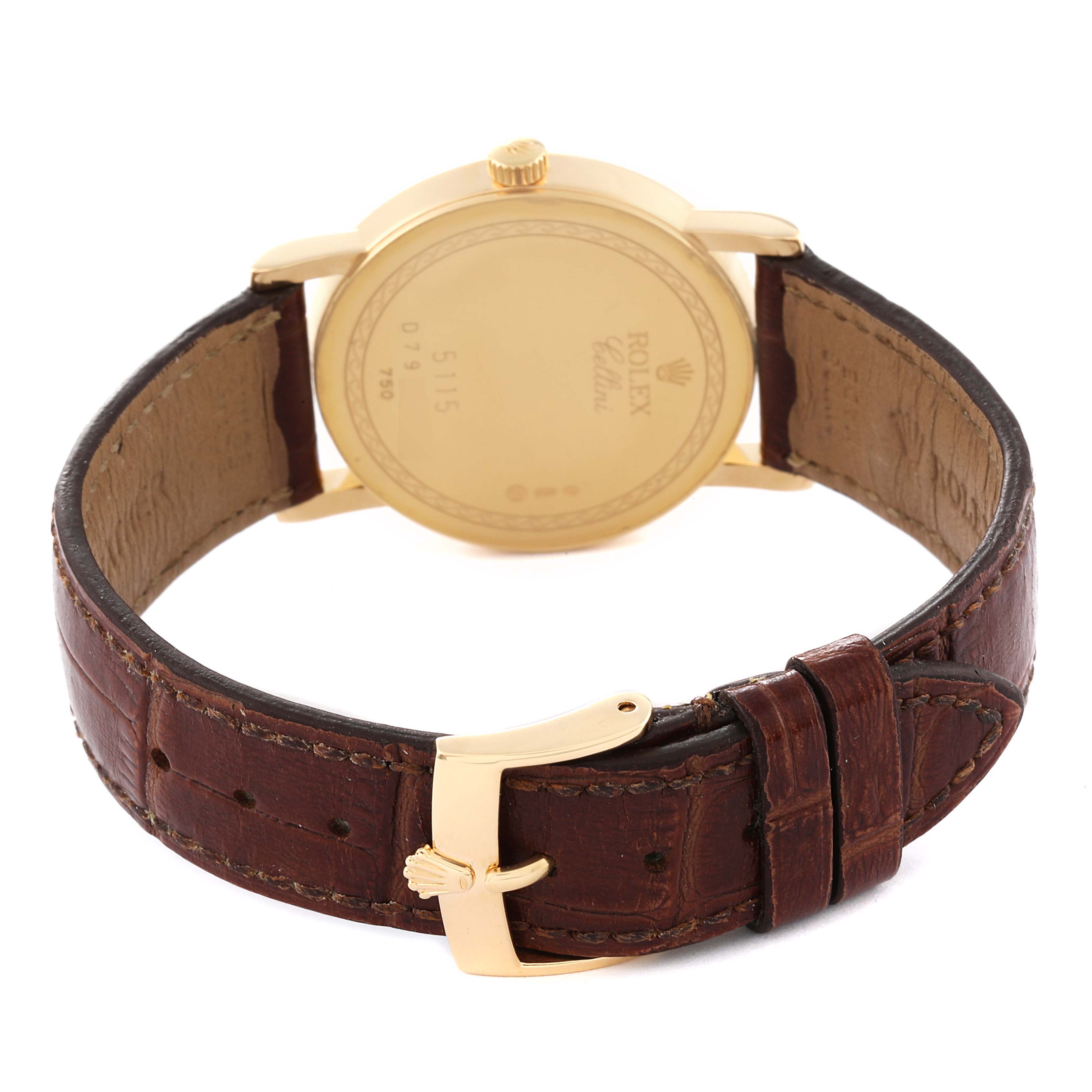 The image shows the back view of a Rolex Cellini 5115 Men's Yellow Gold Champagne Dial 5115 Men's Yellow Gold Champagne Dial watch, highlighting the gold caseback, brown leather strap, and buckle.