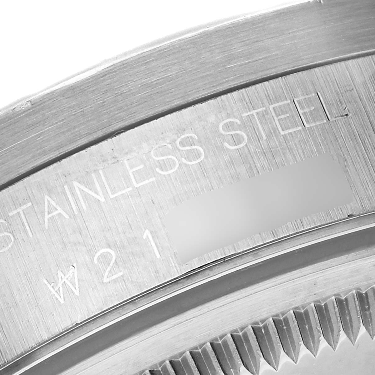 The image shows a close-up of the stainless steel case back of a Rolex Date 15210 Men's Stainless Steel Blue Dial 15210 Men's Stainless Steel Blue Dial model watch.