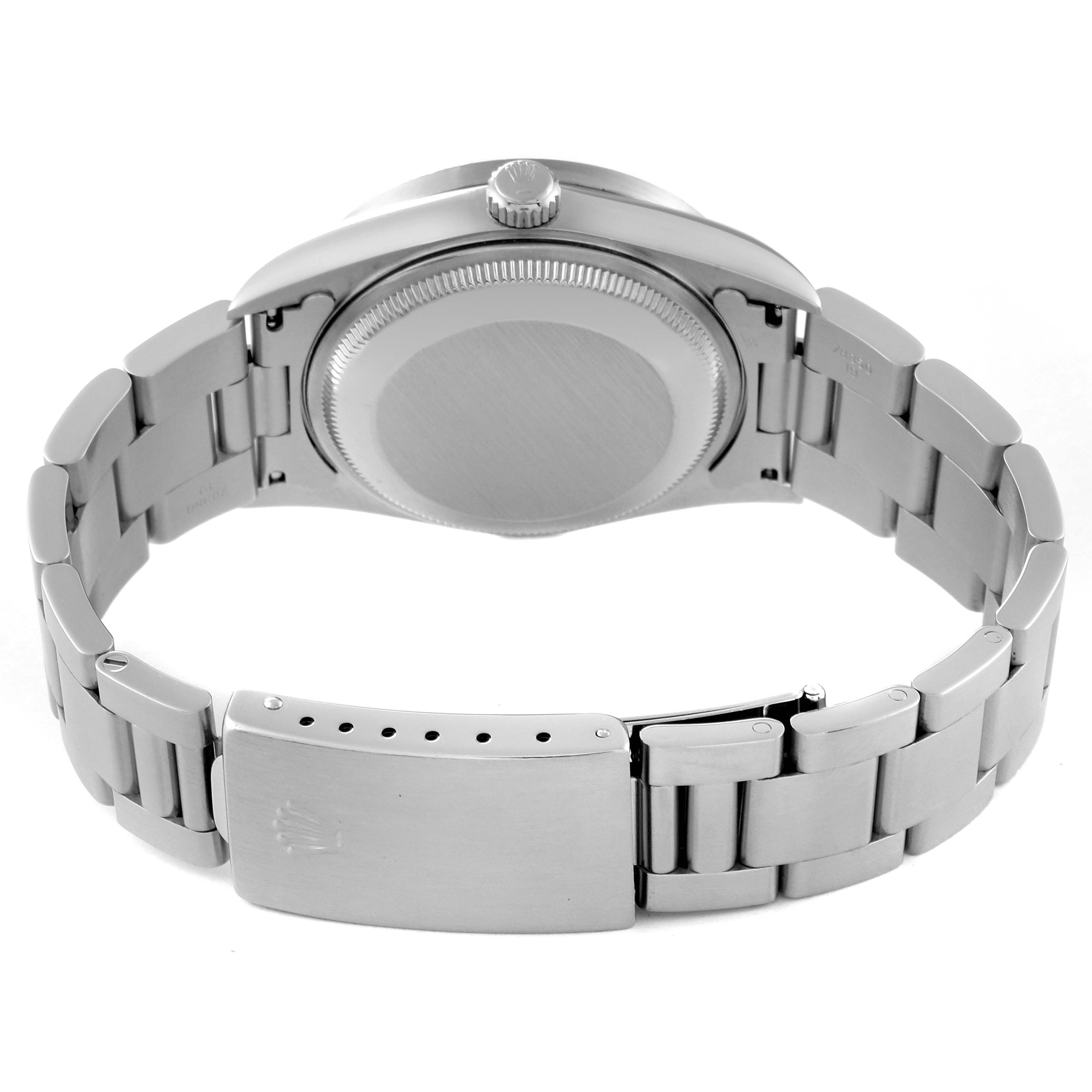 The image shows the back side of a Rolex Date 15210 Men's Stainless Steel Blue Dial 15210 Men's Stainless Steel Blue Dial watch, focusing on the case, crown, and metal bracelet with the clasp.