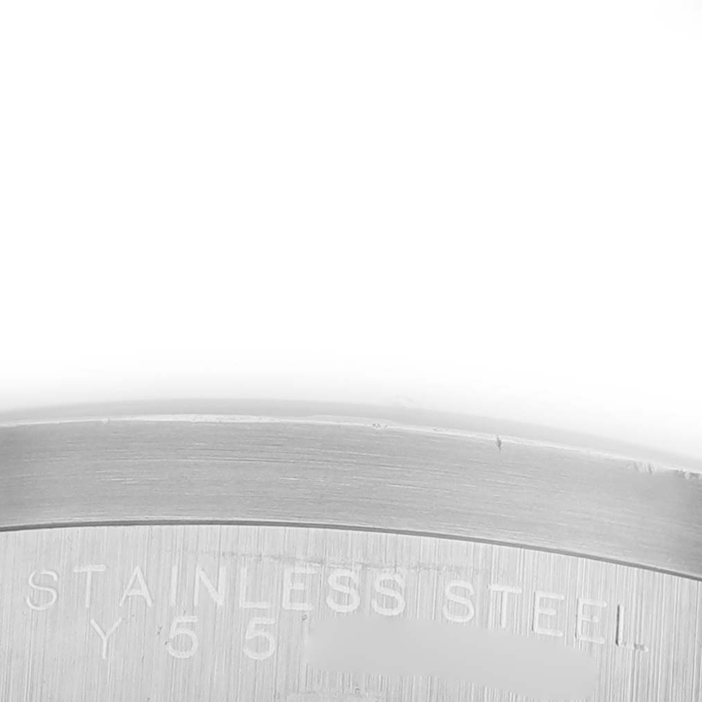 The image shows a close-up of the inner case backing of the Rolex Date 15210 Men's Stainless Steel Black Dial 15210 Men's Stainless Steel Black Dial model, highlighting the "STAINLESS STEEL" engraving.