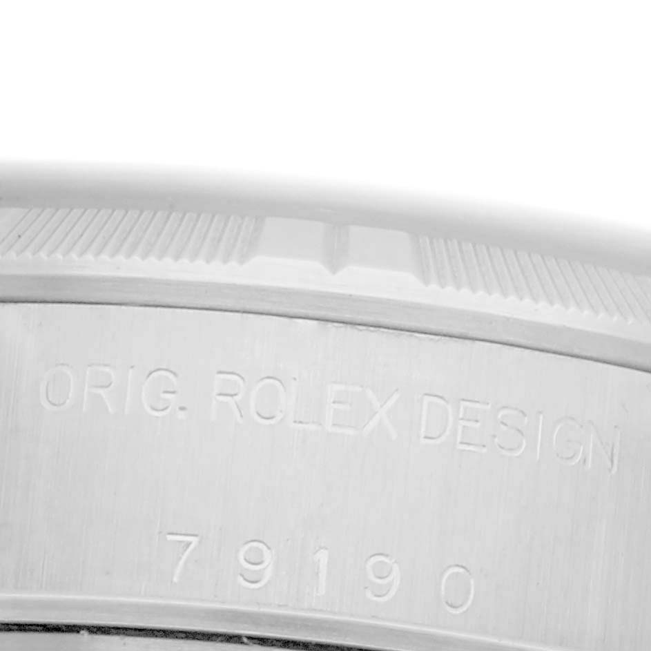 The image shows the side of a Rolex Date 79190 Women's Stainless Steel Pink Dial 79190 Women's Stainless Steel Pink Dial model, featuring engraved text and the model number on its casing.