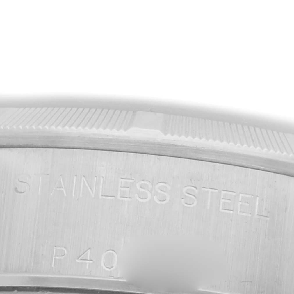 This close-up image shows the side of a Rolex Date 79190 Women's Stainless Steel Pink Dial 79190 Women's Stainless Steel Pink Dial watch case, highlighting the "STAINLESS STEEL" engraving.