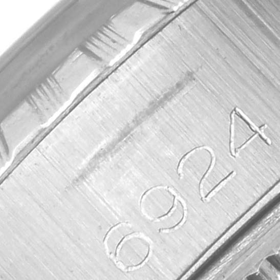 The image shows a close-up of the inner case back of a Rolex Date 6924 Women
s Stainless Steel Silver Dial 6924 Women
s Stainless Steel Silver Dial model, highlighting engraved numbers.
