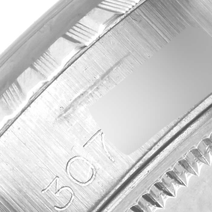 The image shows a close-up of the fluted bezel and part of the rehaut of a Rolex Date 6924 Women
s Stainless Steel Silver Dial 6924 Women
s Stainless Steel Silver Dial model watch.