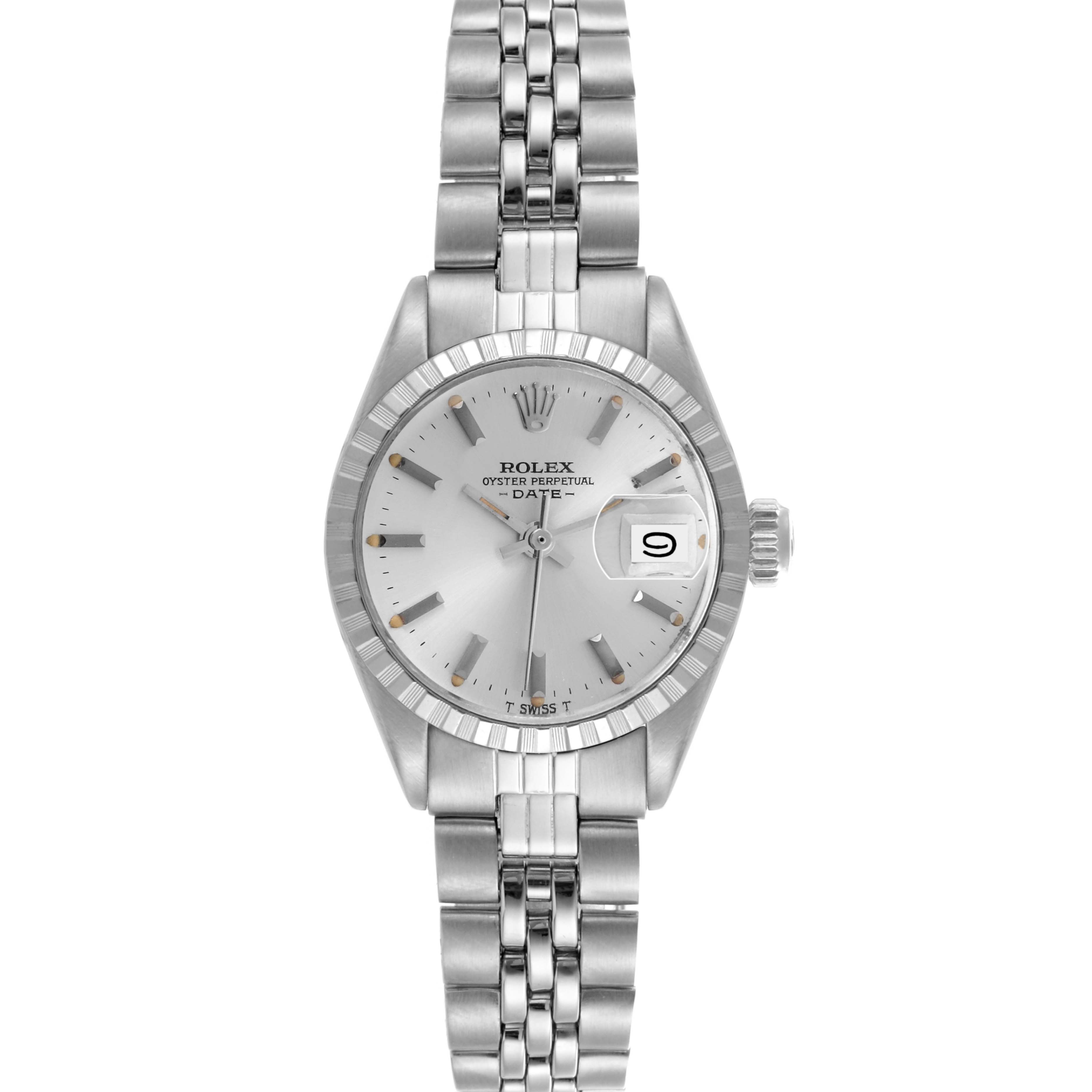 The Rolex Date 6924 Women
s Stainless Steel Silver Dial 6924 Women
s Stainless Steel Silver Dial watch is shown from a top-down angle, highlighting its dial, bezel, and metal bracelet.