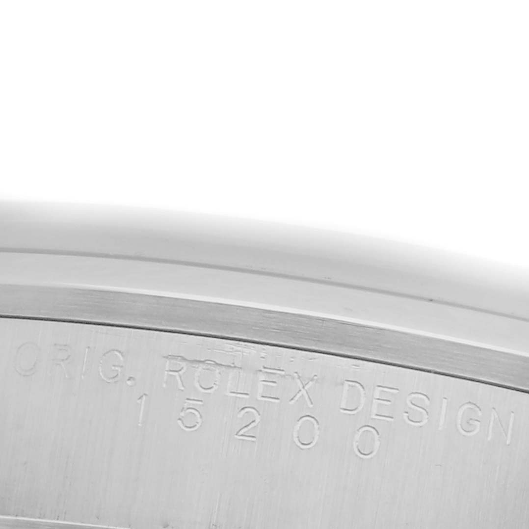 The image shows a close-up of the side of the case of a Rolex Date 15200 Men's Stainless Steel Silver Dial 15200 Men's Stainless Steel Silver Dial model, featuring engraved details.