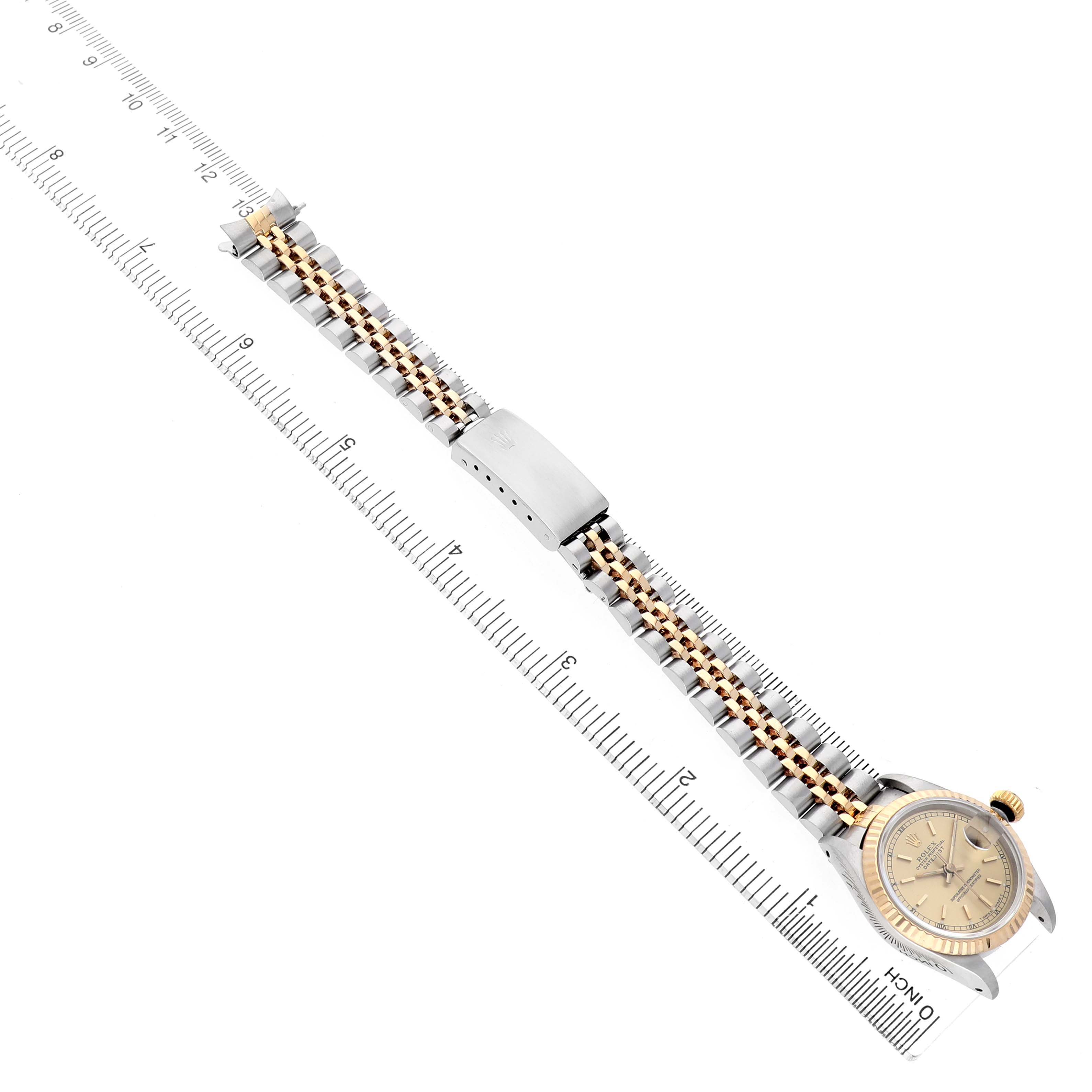 The Rolex Datejust 69173 Women's Steel and Gold (two tone) Champagne Dial watch is shown from a top-down angle, displaying the full face, bracelet, and clasp.