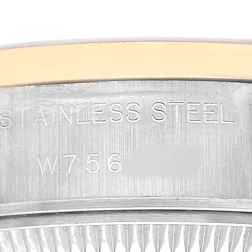 The image shows a close-up of the side engraving on the case of a Rolex Datejust 69163 Women's Steel and Gold (two tone) Champagne Dial, highlighting the stainless steel marking and serial number.