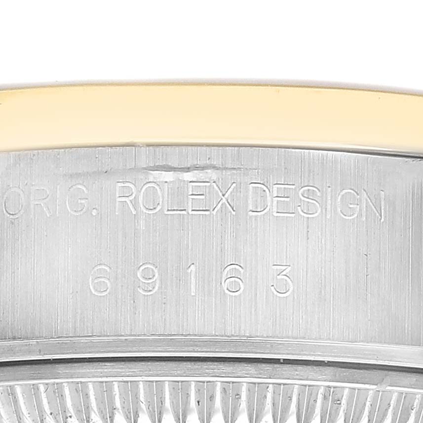 The image shows a close-up of the side of a Rolex Datejust 69163 Women's Steel and Gold (two tone) Champagne Dial, highlighting the engraved serial number and "ROLEX DESIGN."