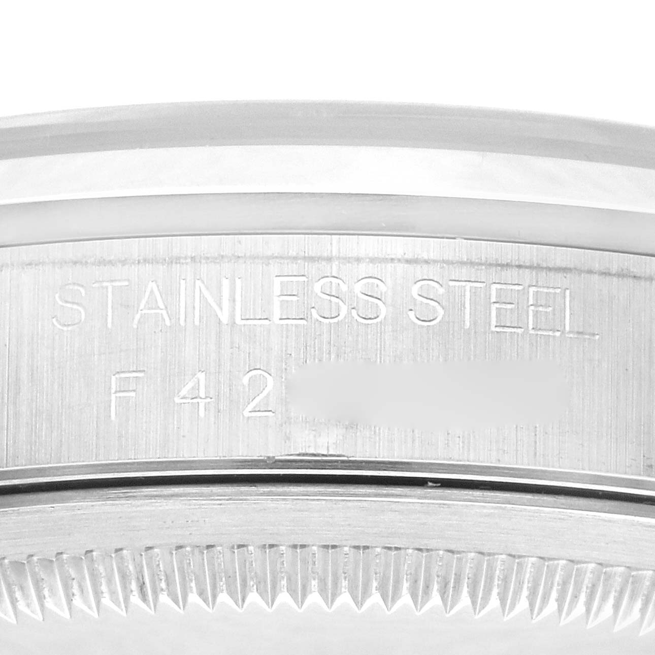 This is a close-up view of the side of a Rolex Datejust 16200 Men's Stainless Steel Black Dial 16200 Men's Stainless Steel Black Dial watch showing the stainless steel engraving and serial number.