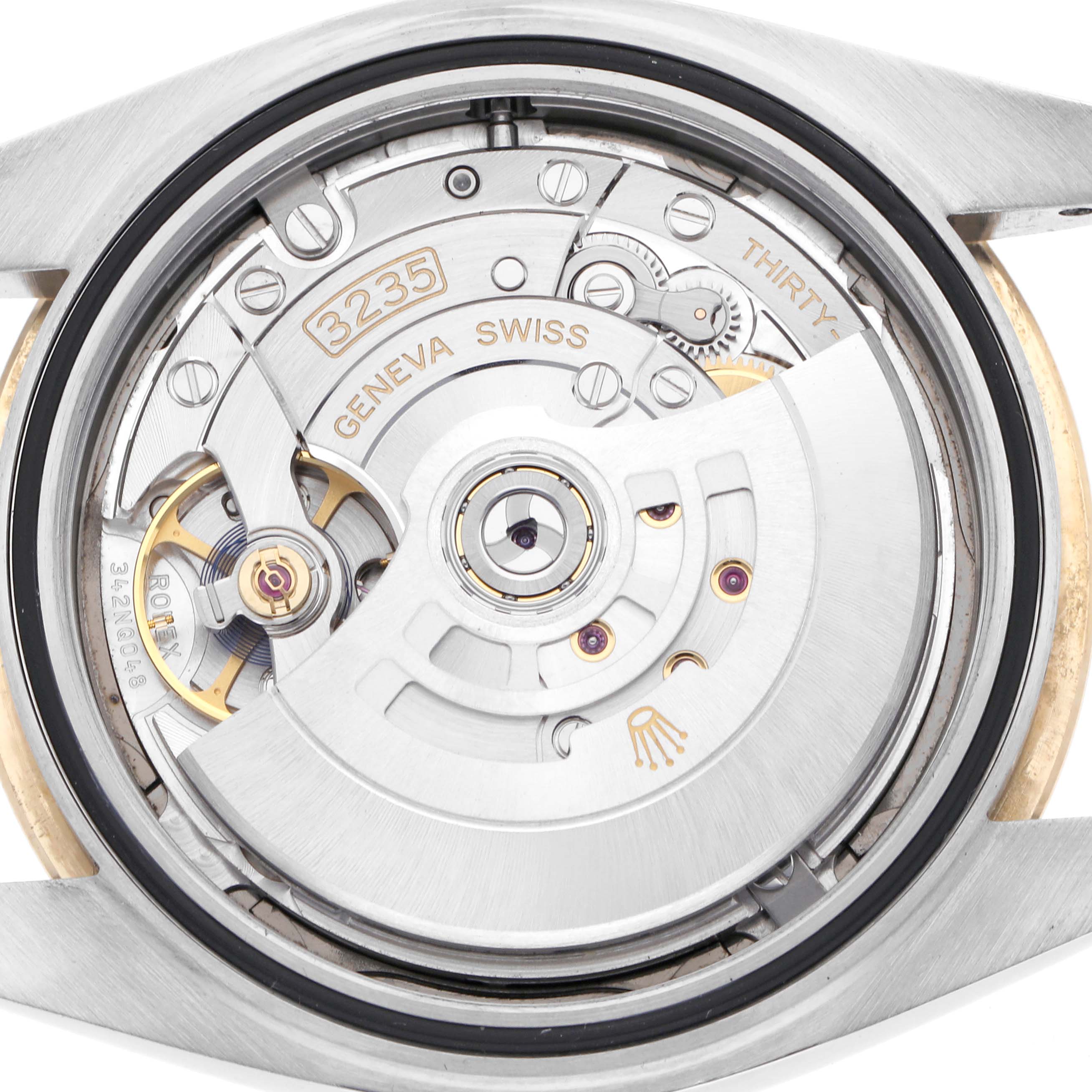 The image shows the open case back of a Rolex Datejust 41 126303 Men's Steel and Gold (two tone) Grey Dial 126303 Men's Steel and Gold (two tone) Grey Dial, revealing its movement and intricate components.