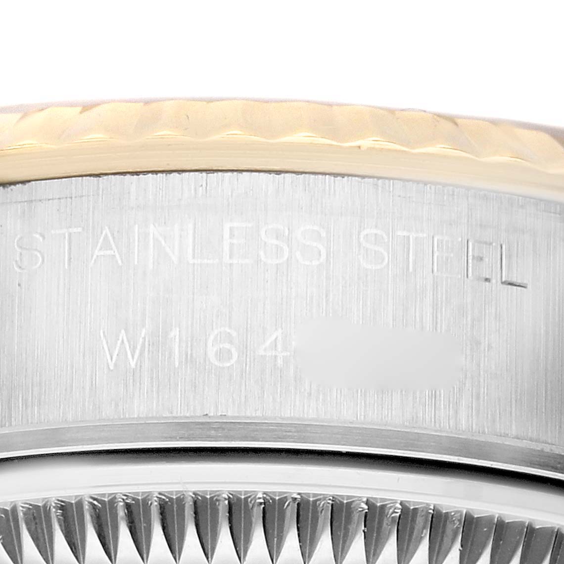 The image shows a close-up of the side and edge of the bezel of a Rolex Datejust 69173 Women's Steel and Gold (two tone) Champagne Dial 69173 Women's Steel and Gold (two tone) Champagne Dial watch, with part of the serial number visible.