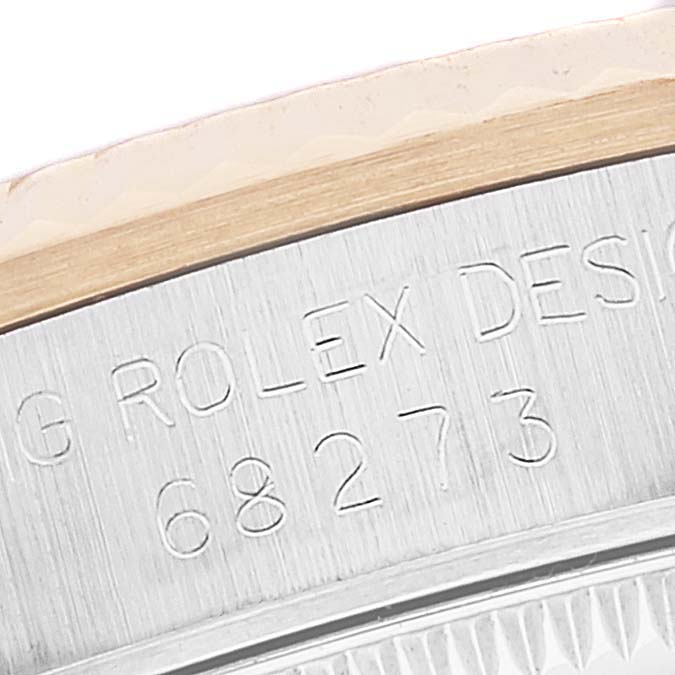 The close-up image shows the side view of a Rolex Mid-Size 68273 Women
s Steel and Gold (two tone) Black Dial 68273 Women
s Steel and Gold (two tone) Black Dial watch, focusing on the engraved model number and brand name.